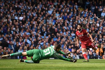 Manchester City's Brazilian goalkeeper Ederson (L) saves a shot from Liverpool's Egyptian midfielder Mohamed Salah during the English Premier League football match between Manchester City and Liverpool at the Etihad Stadium in Manchester, north west Engla