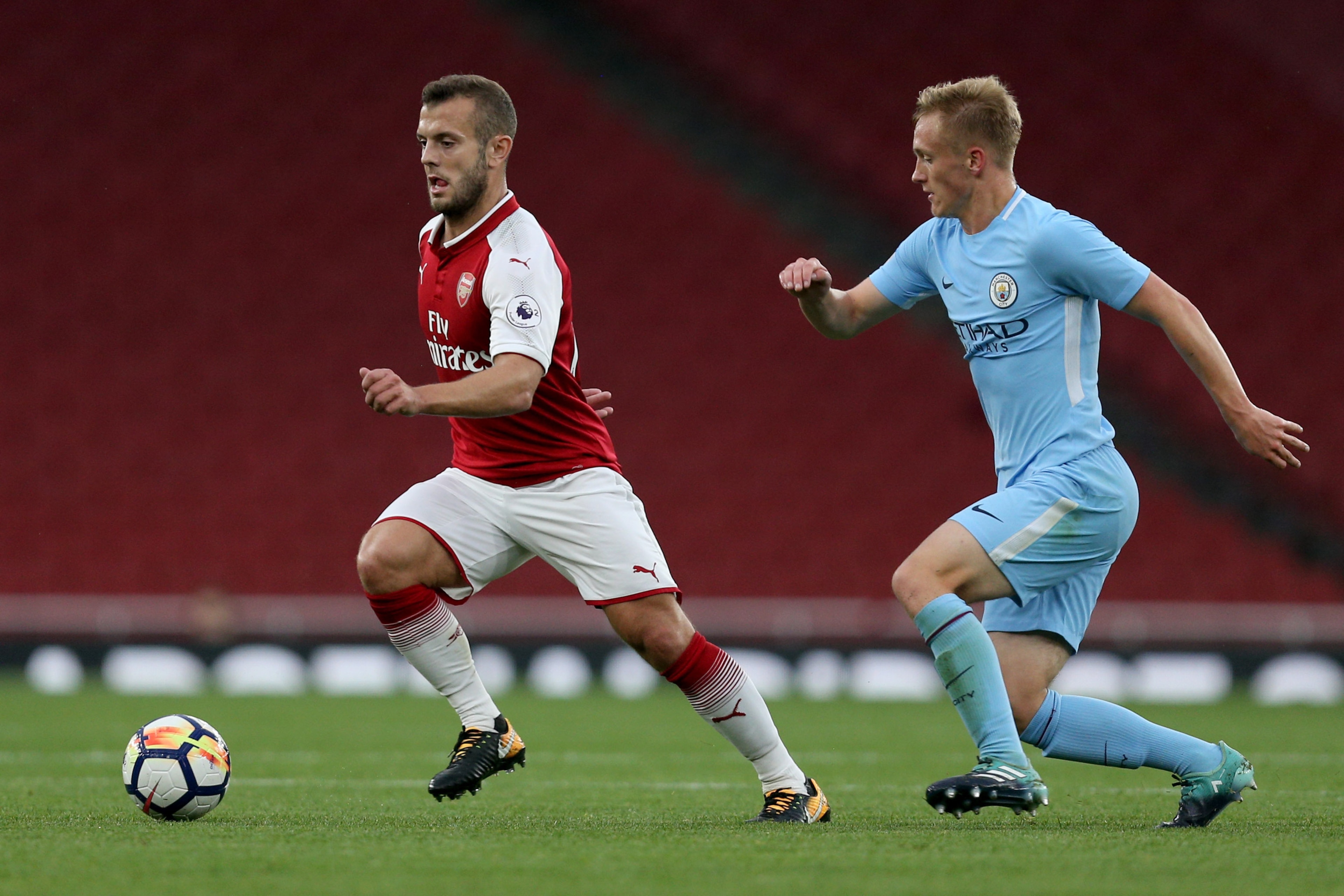 LONDON, ENGLAND - AUGUST 21: Jack Wilshere of Arsenal takes the ball past Matthew Smith of Manchester City during the Premier League 2 match between Arsenal v Manchester City at Emirates Stadium on August 21, 2017 in London, England.  (Photo by James Chan