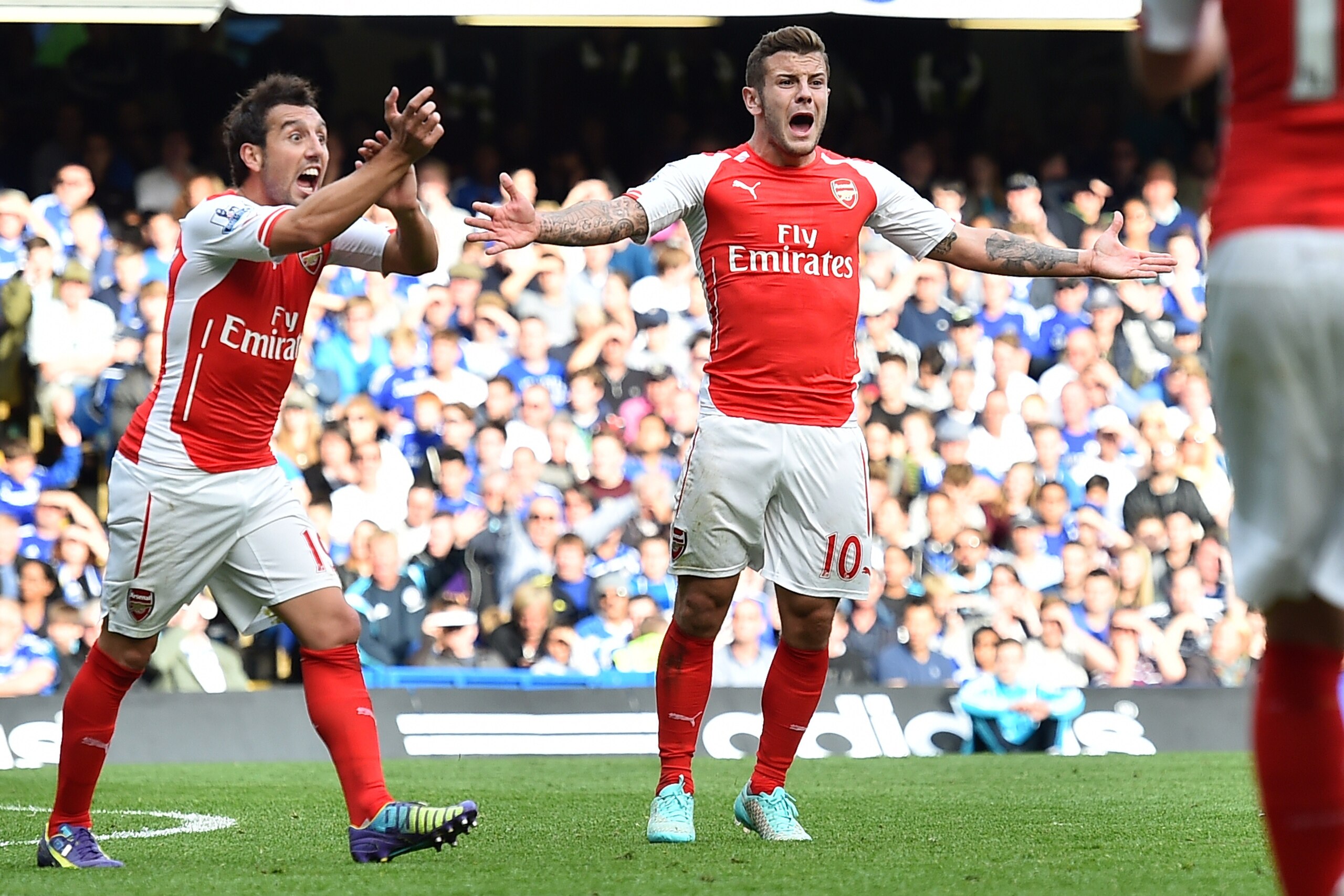 Arsenal's Spanish midfielder Santi Cazorla (L) and English midfielder Jack Wilshere (R) appeal for a handball during the English Premier League football match between Chelsea and Arsenal at Stamford Bridge in London on October 5, 2014. Chelsea won the gam
