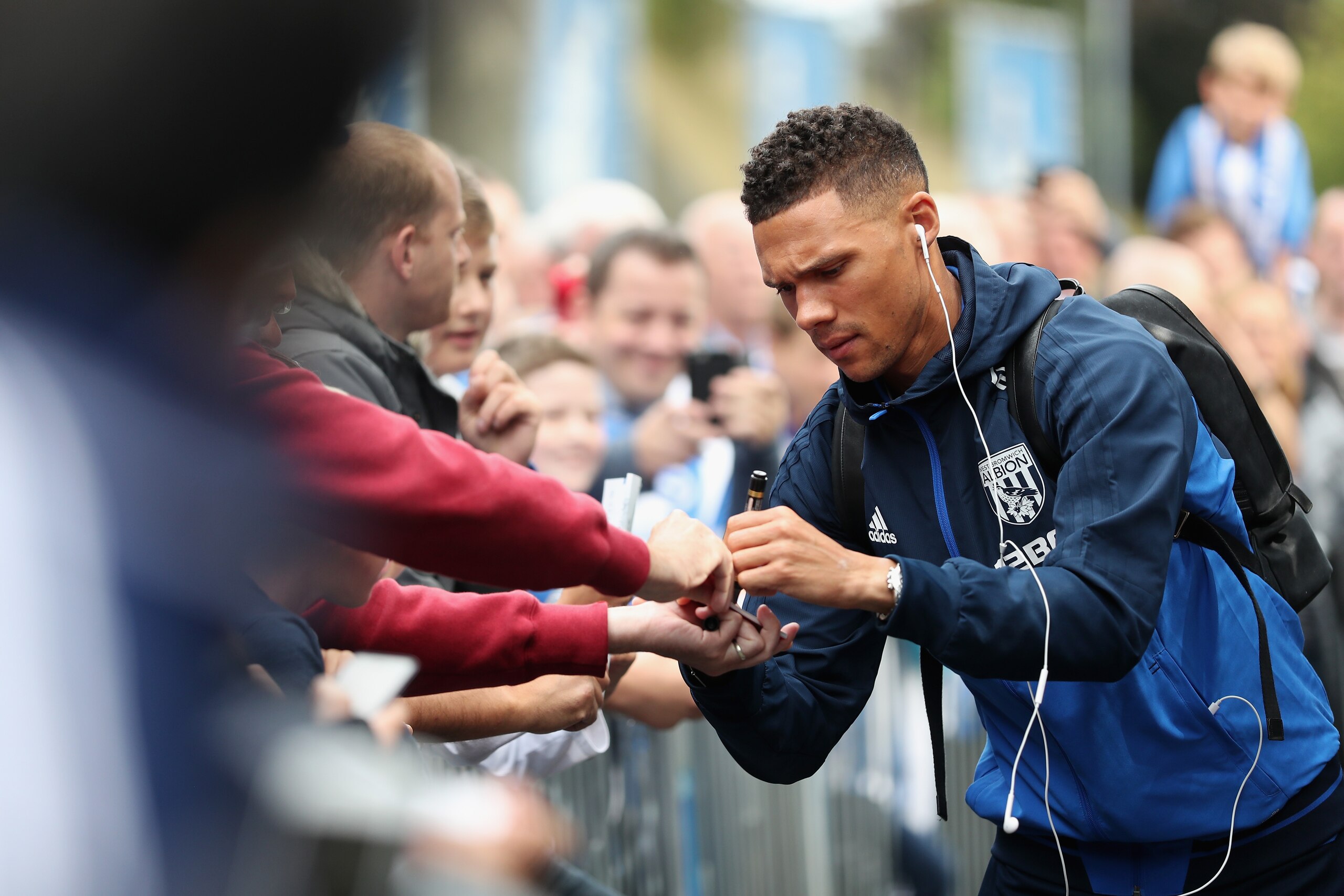 BRIGHTON, ENGLAND - SEPTEMBER 09: Kieran Gibbs of West Bromwich Albion signs autographs as he arrives at the stadium prior to the Premier League match between Brighton and Hove Albion and West Bromwich Albion at Amex Stadium on September 9, 2017 in Bright