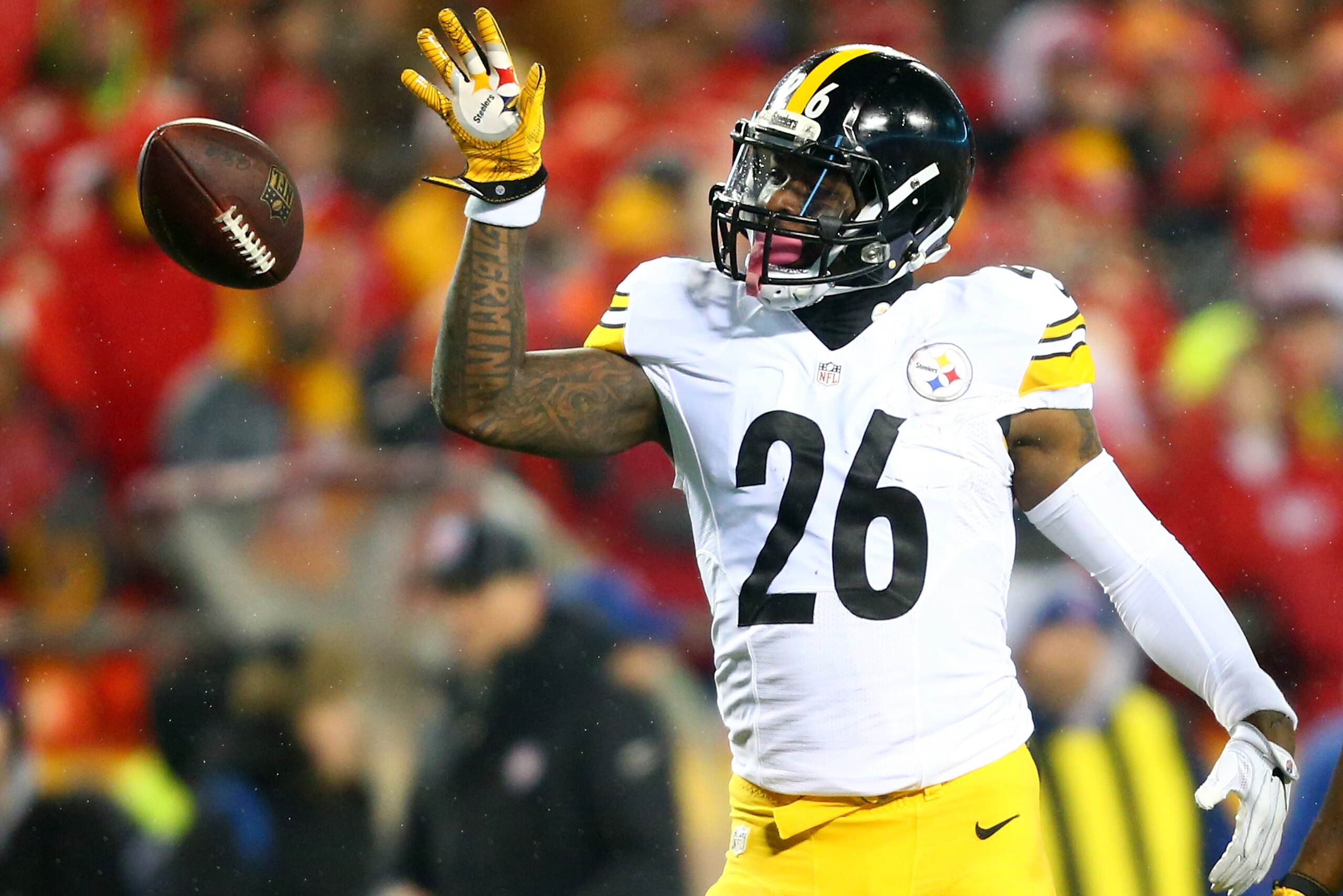 KANSAS CITY, MP - JANUARY 15:  Running back Le'Veon Bell #26 of the Pittsburgh Steelers tosses the ball forward after gaining a first down against the Kansas City Chiefs during the first quarter in the AFC Divisional Playoff game at Arrowhead Stadium on J