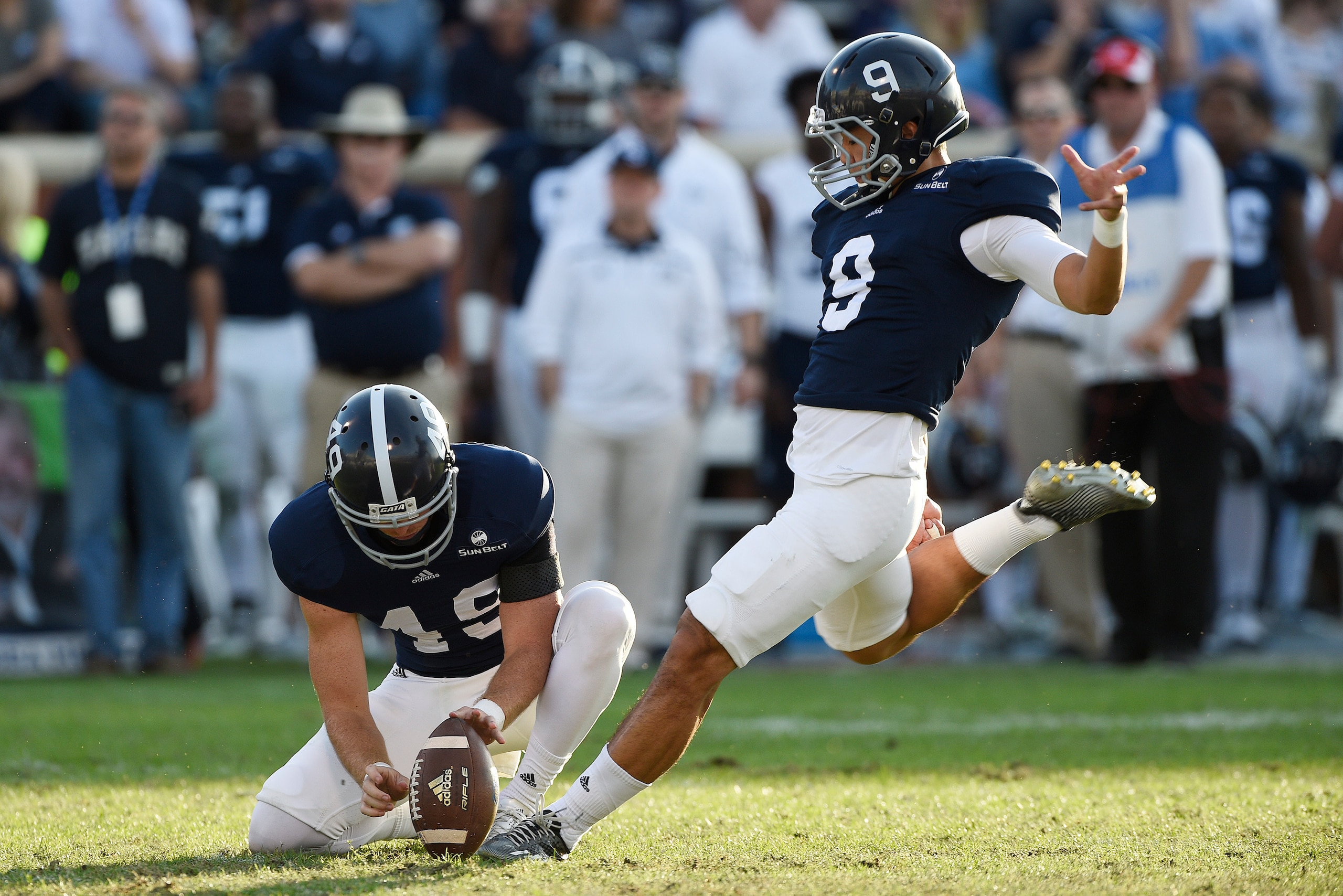 STATESBORO, GA - NOVEMBER 28:  Punter Ryan Nowicki #49 of the Georgia Southern Eagles holds the ball for kicker Younghoe Koo #9 during a field goal attempt against the South Alabama Jaguars during the third quarter on November 28, 2015 at Paulson Stadium 