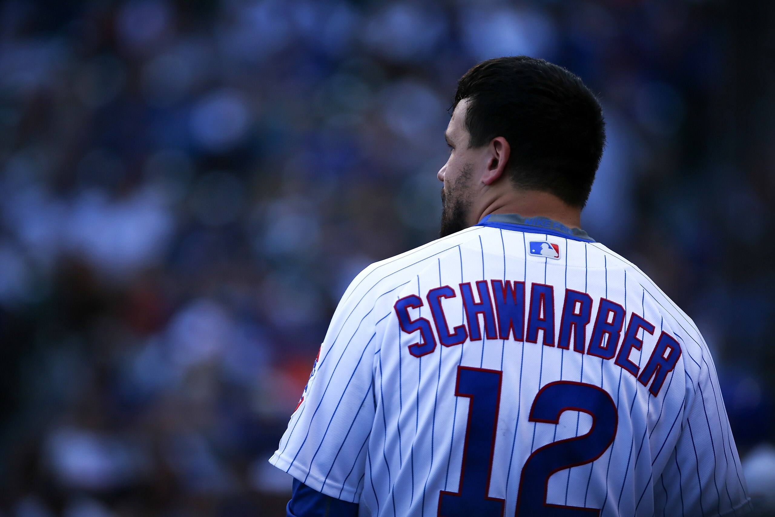 CHICAGO, IL - AUGUST 17:  Kyle Schwarber #12 of the Chicago Cubs looks on from the dugout in the eighth inning against the Cincinnati Reds at Wrigley Field on August 17, 2017 in Chicago, Illinois. (Photo by Dylan Buell/Getty Images)