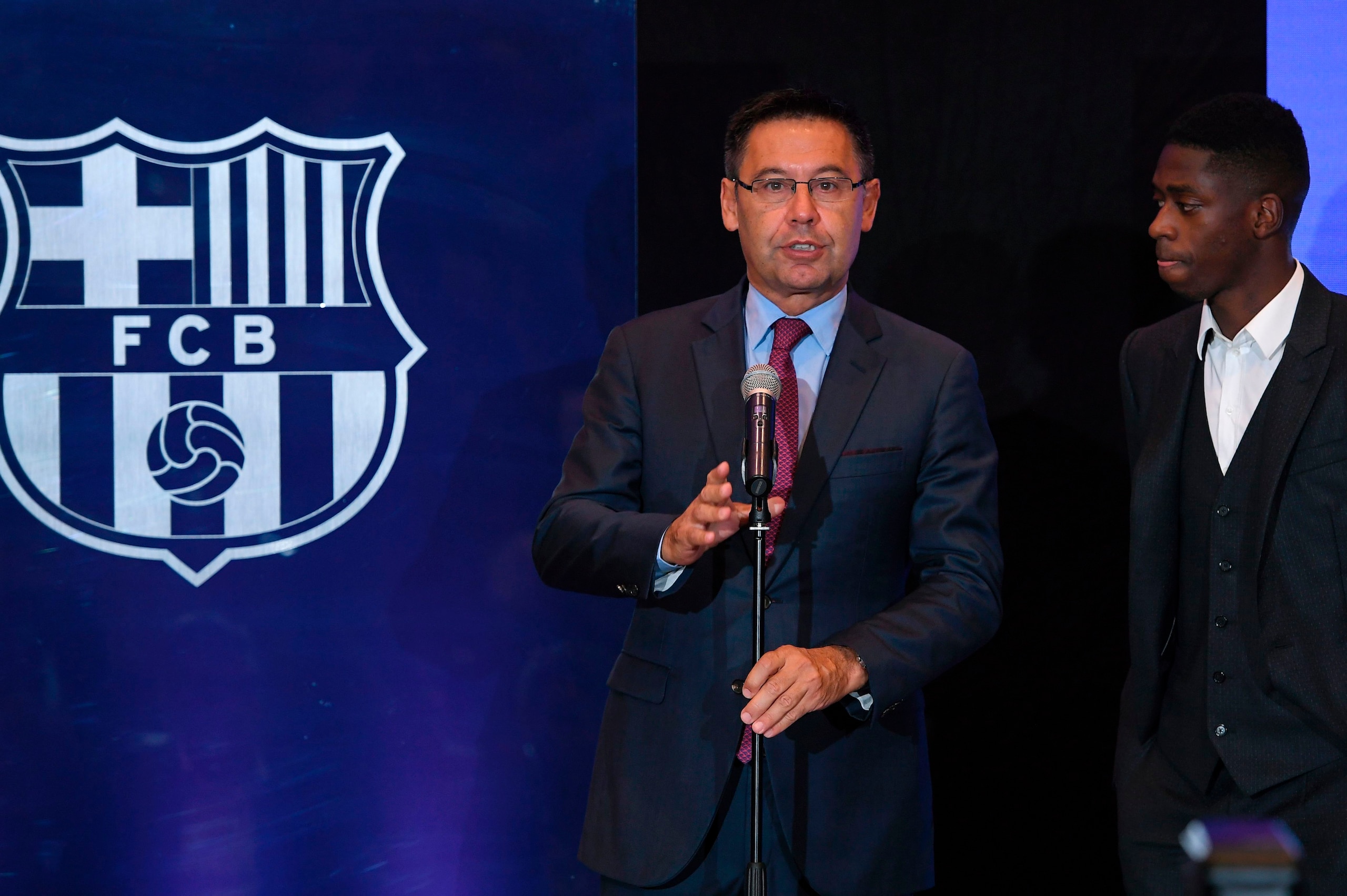 Barcelona's president Josep Maria Bartomeu (L) delivers a speech next to Barcelona's new player Ousmane Dembele at the Camp Nou stadium in Barcelona, during his official presentation at the Catalan football club, on August 28, 2017.
French starlet Ousmane