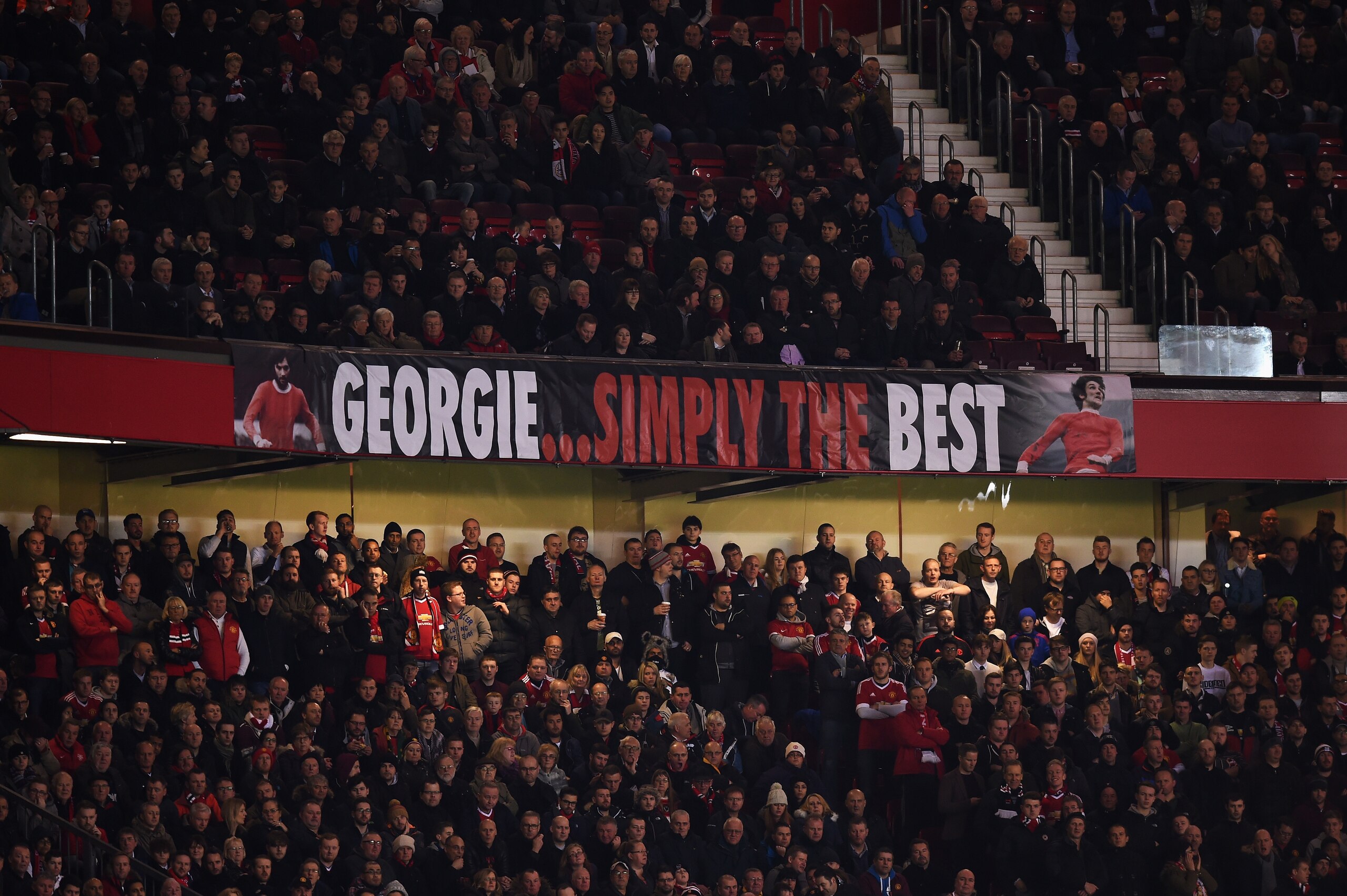 MANCHESTER, ENGLAND - NOVEMBER 25: Fans display a banner as they remember former Manchester United player George Best during the UEFA Champions League Group B match between Manchester United FC and PSV Eindhoven at Old Trafford on November 25, 2015 in Man