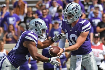 MANHATTAN, KS - SEPTEMBER 09:  Quarterback Alex Delton #10 of the Kansas State Wildcats hands the ball off to running back Tyler Burns #33 against the Charlotte 49ers during the second half on September 9, 2017 at Bill Snyder Family Stadium in Manhattan, 