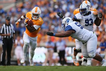 Sep 9, 2017; Knoxville, TN, USA; Tennessee Volunteers running back John Kelly (4) carries the ball past Indiana State Sycamores defensive tackle Norvell McGlaun (52) in the second half at Neyland Stadium. Tennessee defeated Indiana State 42-7. Mandatory C