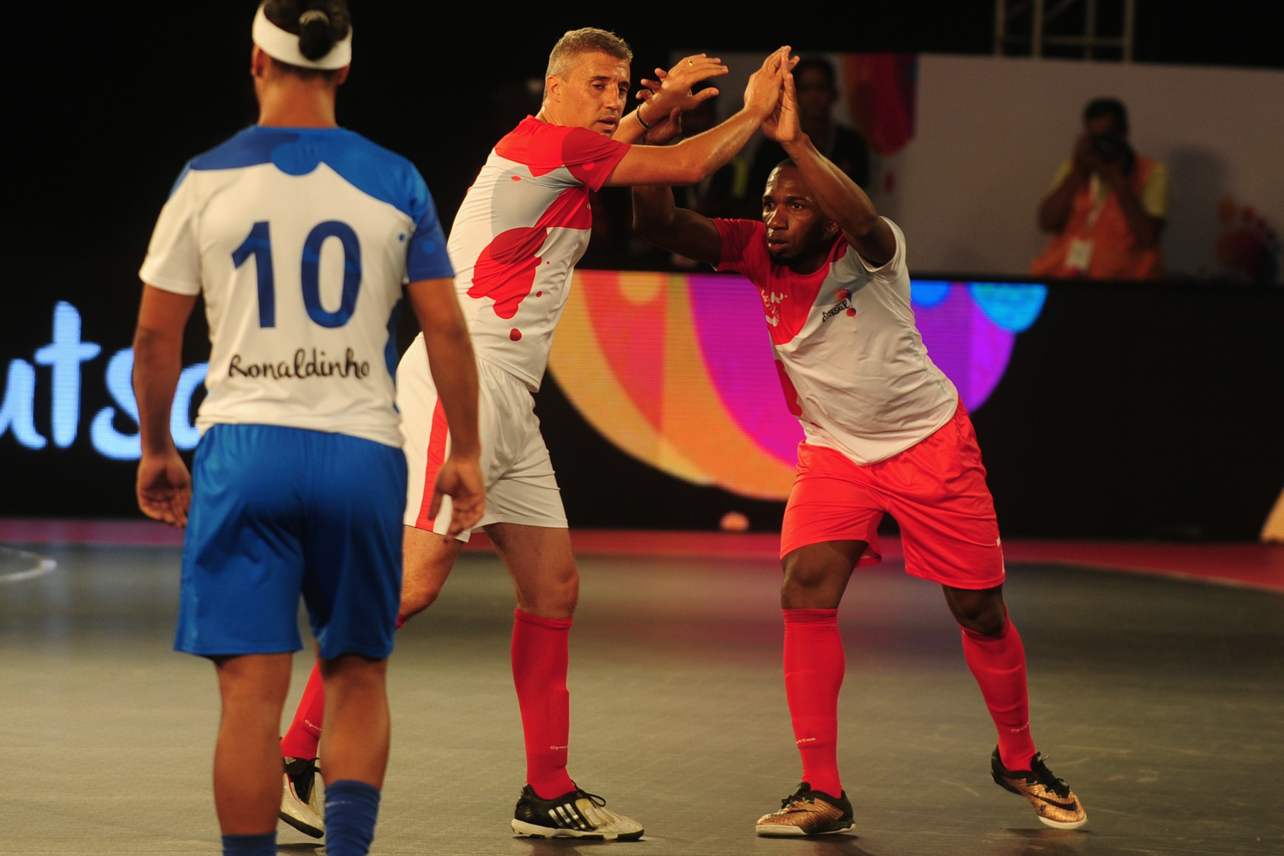 Kolkata 5's Hernan Crespo (C) celebarates with Pula after scoring a goal against the Goa 5's during their Premier Futsal Football League match in Chennai on July 15, 2016. / AFP / ARUN SANKAR        (Photo credit should read ARUN SANKAR/AFP/Getty Images)