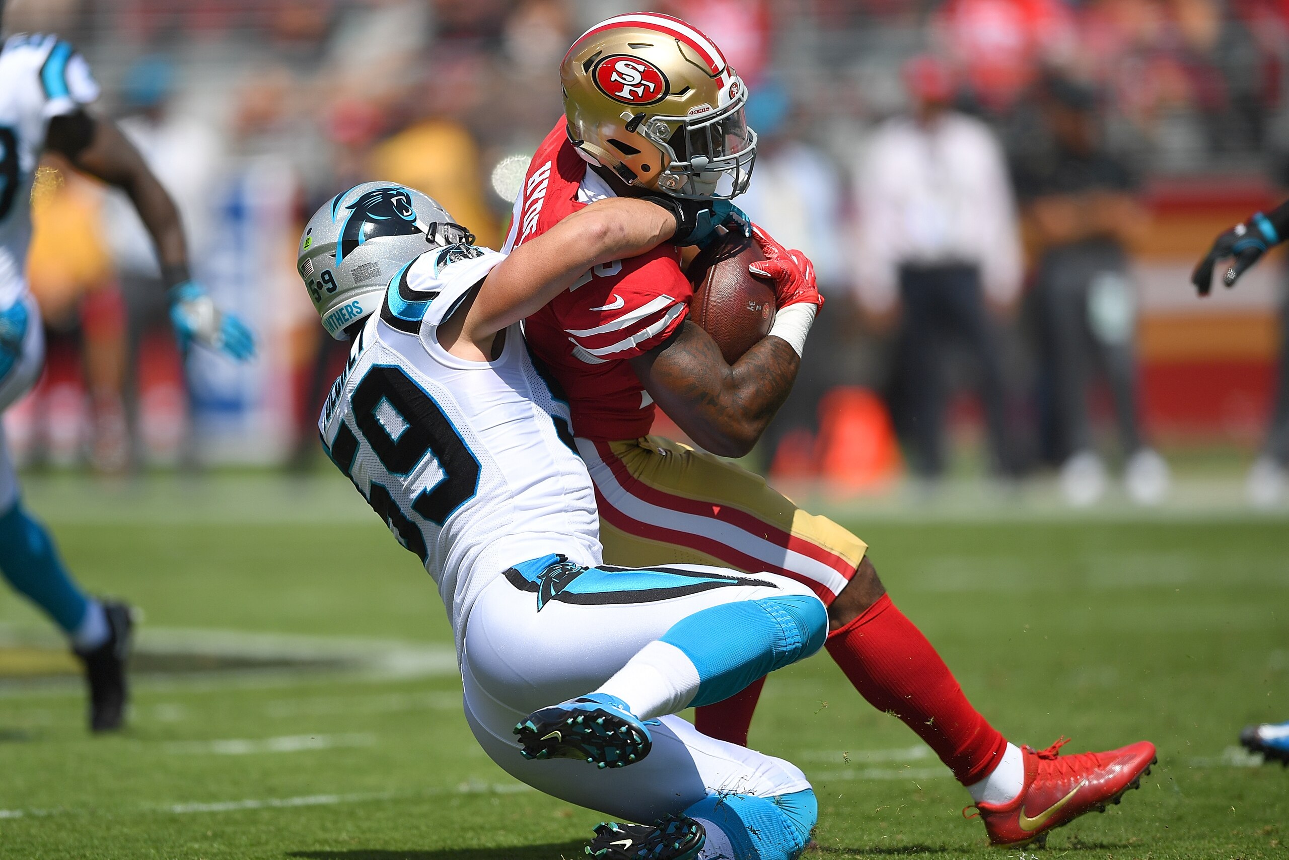 SANTA CLARA, CA - SEPTEMBER 10:  Carlos Hyde #28 of the San Francisco 49ers gets tackled by Luke Kuechly #59 of the Carolina Panthers during the first quarter of their NFL football game at Levi's Stadium on September 10, 2017 in Santa Clara, California.  
