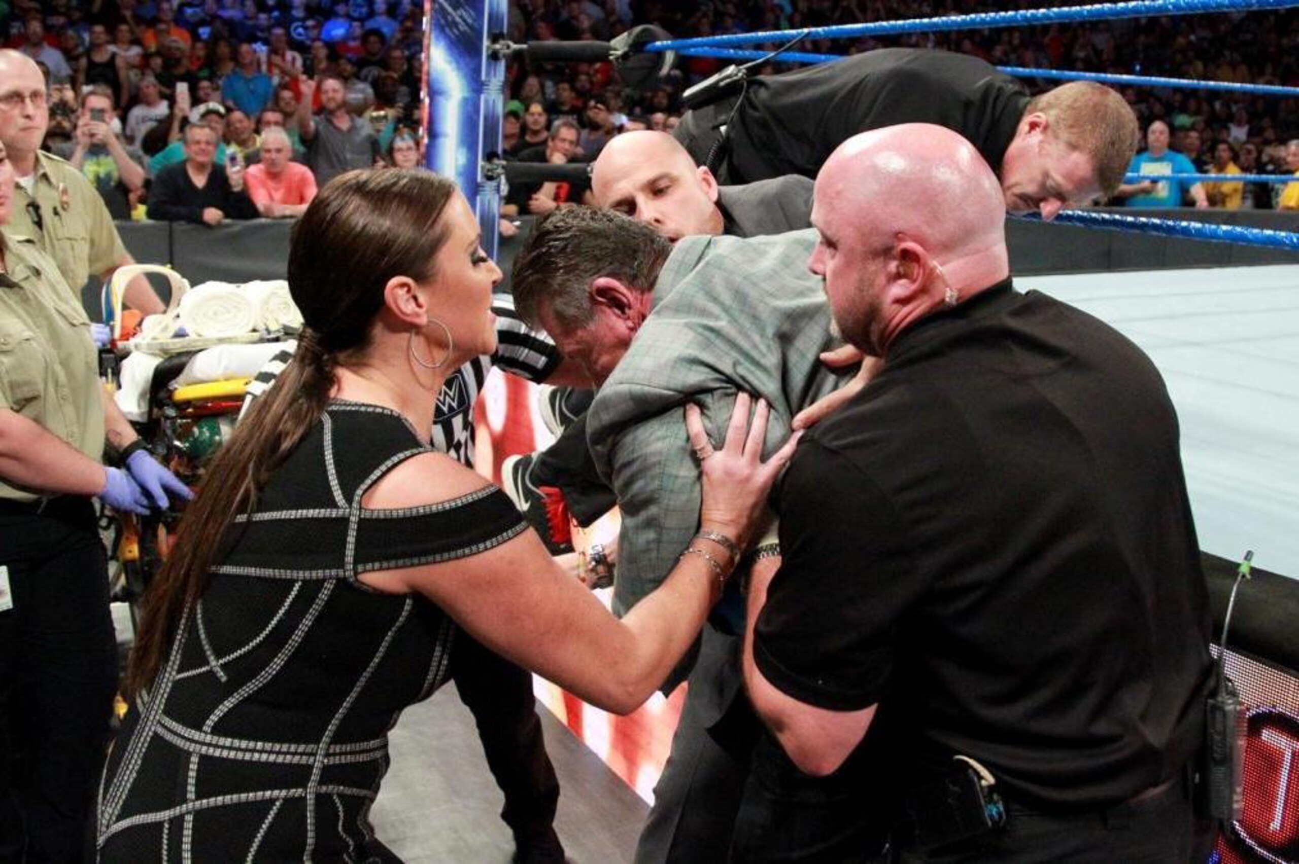 Stephanie McMahon attends to her father.