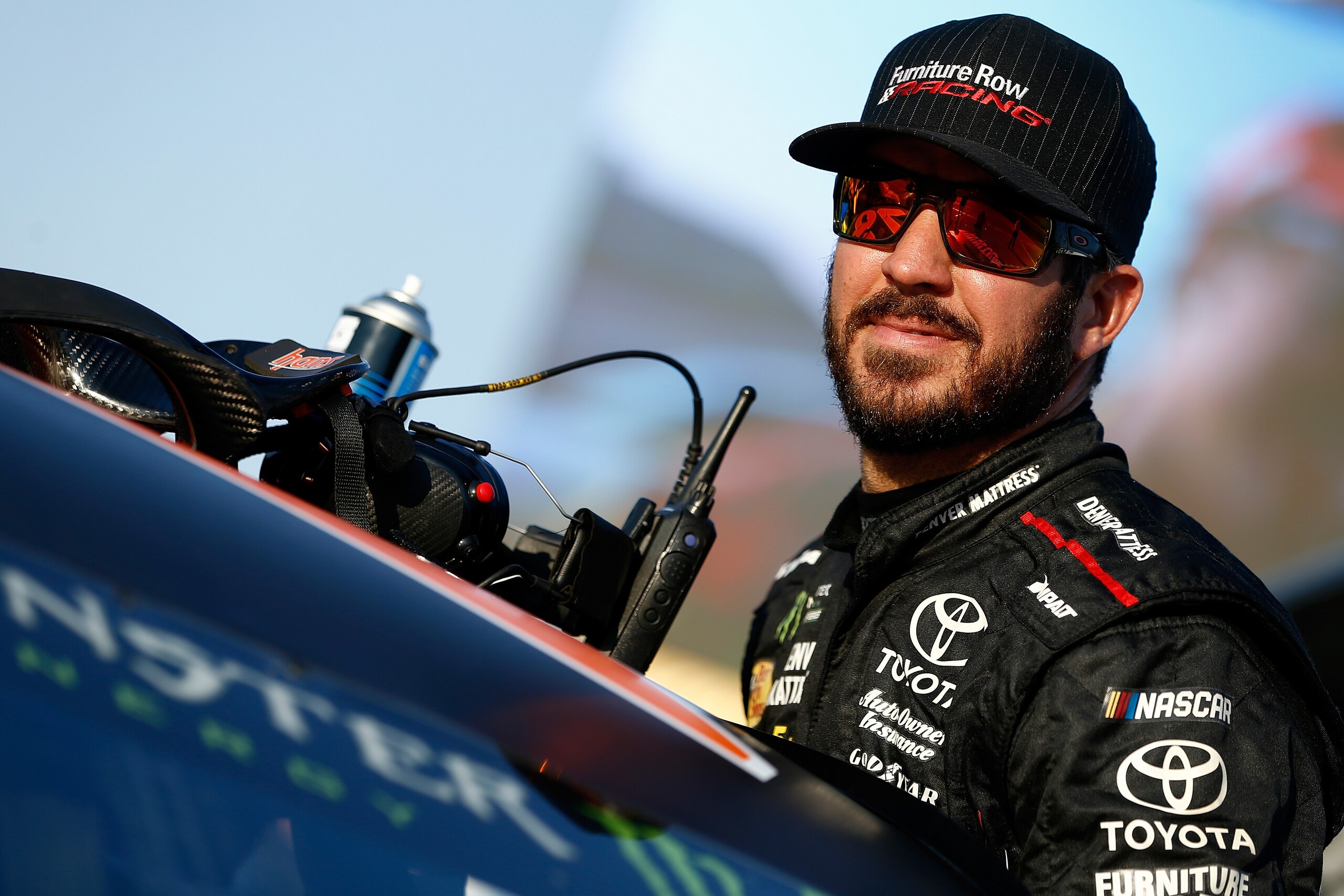 JOLIET, IL - SEPTEMBER 15:  Martin Truex Jr., driver of the #78 Furniture Row/Denver Mattress Toyota, sits in his car during qualifying for the NASCAR Camping World Truck Series TheHouse.com 225 at Chicagoland Speedway on September 15, 2017 in Joliet, Ill