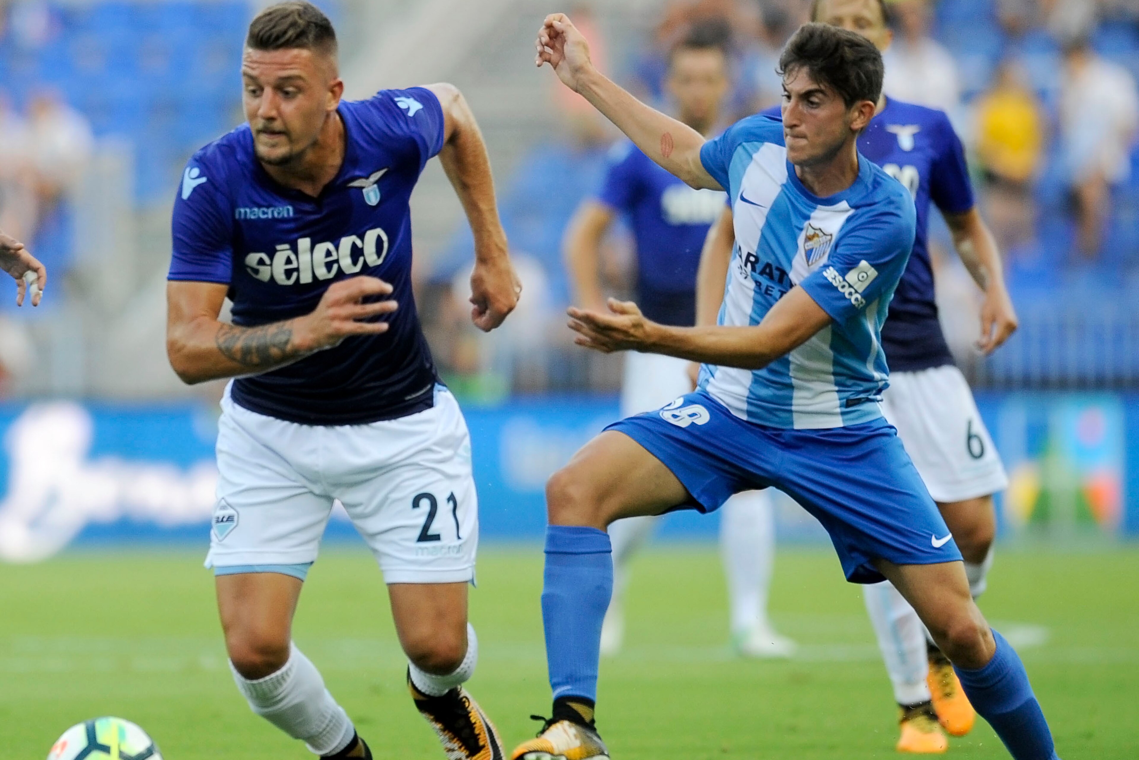 MALAGA, MALAGA - AUGUST 05:  Sergej Milinkovic Savic of SS Lazio compete for the ball with Mula of Malaga CF during the Pre-Season Friendly match between Malaga CF and SS Lazio at Estadio La Rosaleda on August 5, 2017 in Malaga, Spain.  (Photo by Marco Ro