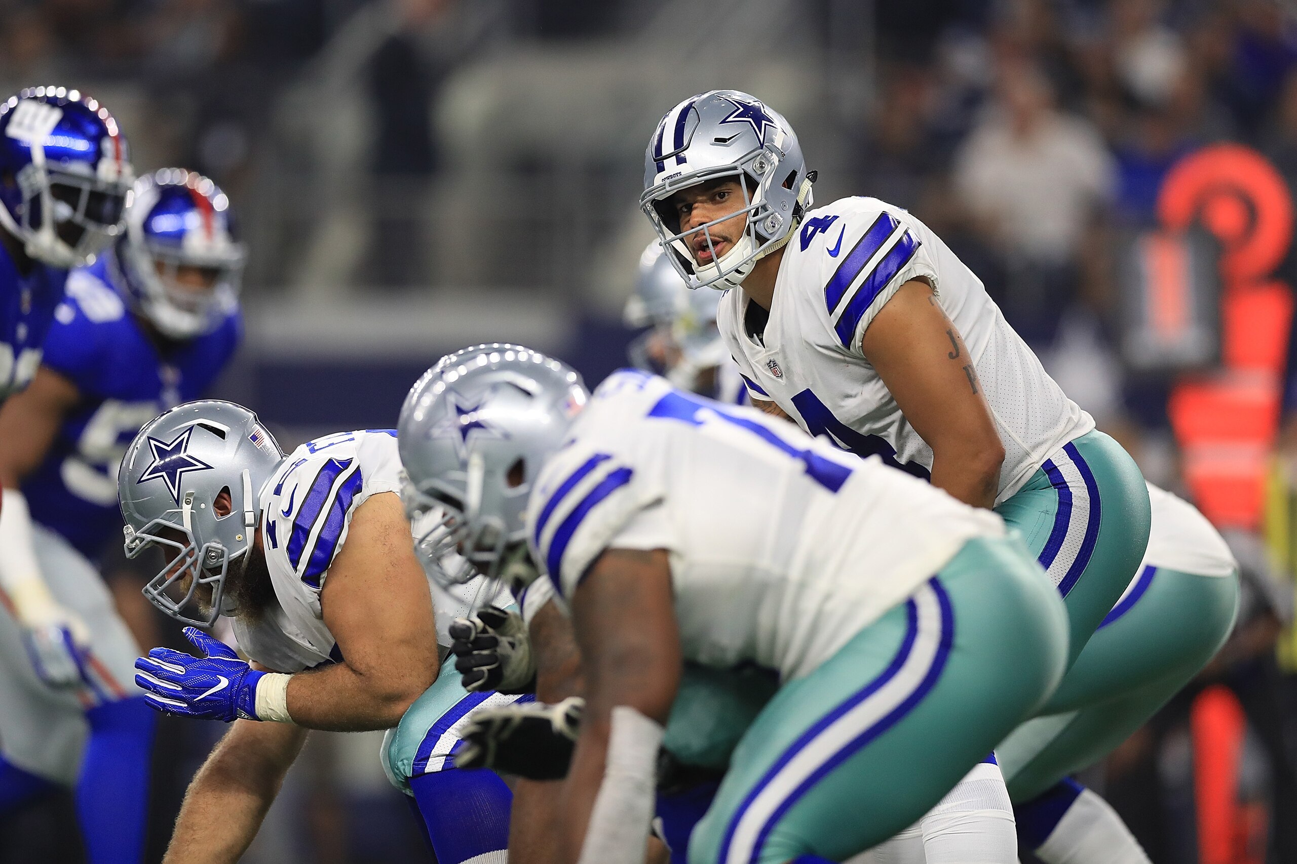 ARLINGTON, TX - SEPTEMBER 10:  Dak Prescott #4 of the Dallas Cowboys stands behind center in the second half of a game against the New York Giants  at AT&T Stadium on September 10, 2017 in Arlington, Texas.  (Photo by Ronald Martinez/Getty Images)