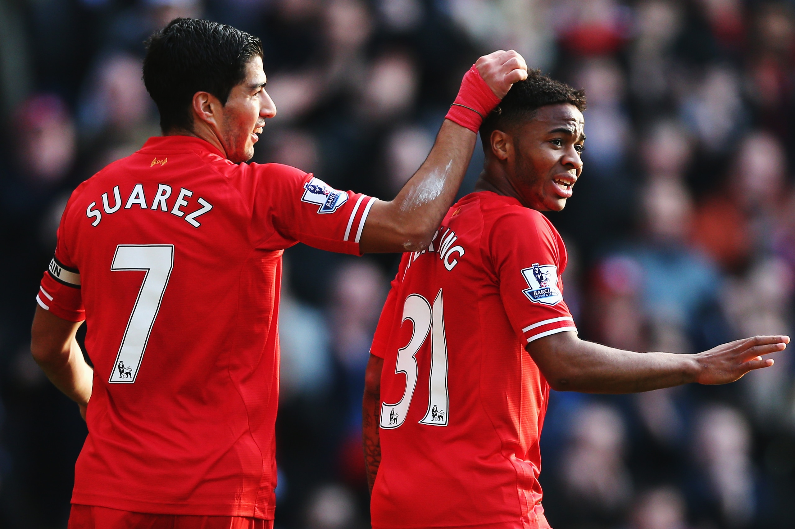 LIVERPOOL, ENGLAND - DECEMBER 21:  (L-R) Luis Suarez and Raheem Sterling of Liverpool react during the Barclays Premier League match between Liverpool and Cardiff City at Anfield on December 21, 2013 in Liverpool, England.  (Photo by Clive Brunskill/Getty
