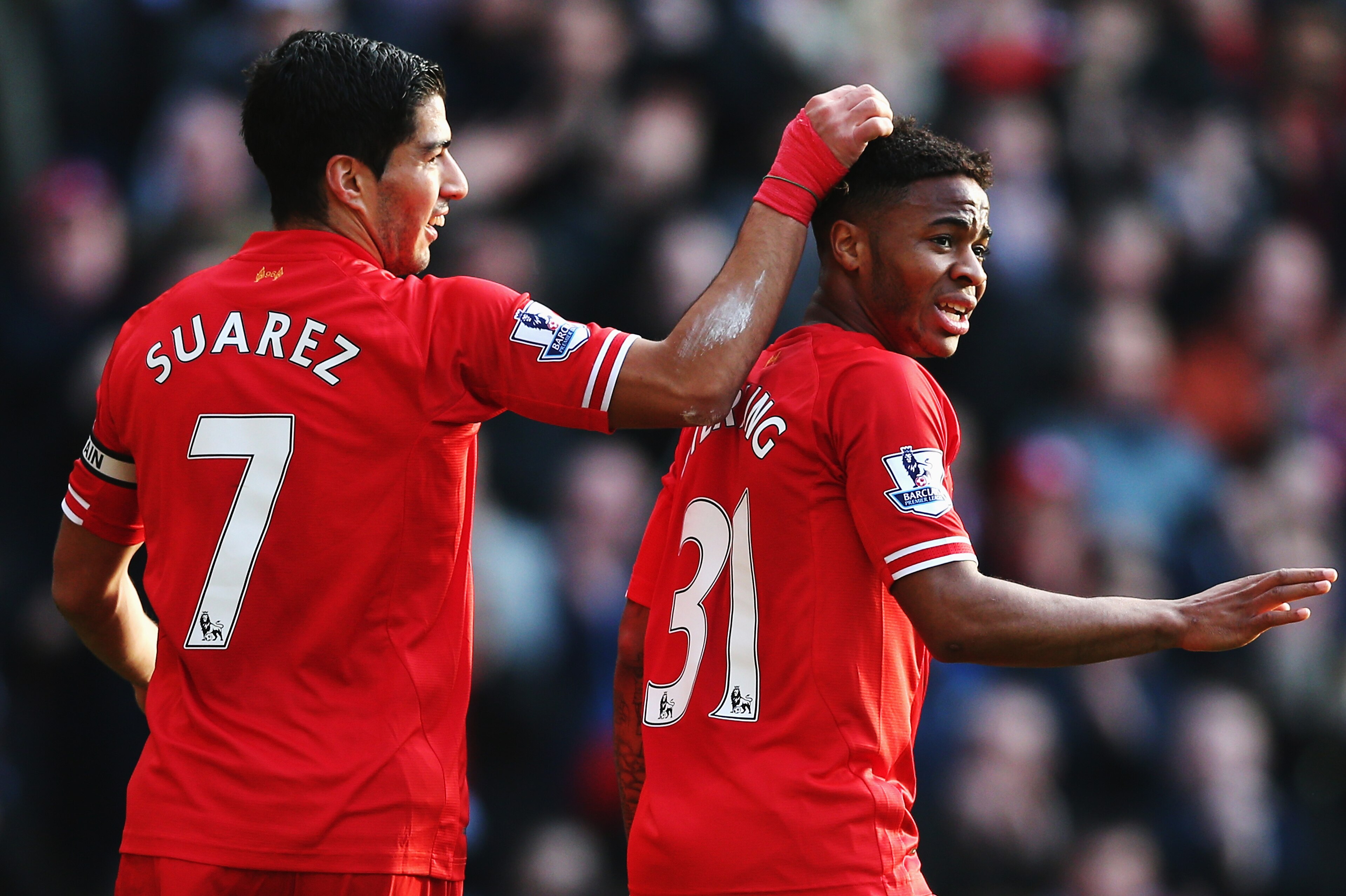LIVERPOOL, ENGLAND - DECEMBER 21:  (L-R) Luis Suarez and Raheem Sterling of Liverpool react during the Barclays Premier League match between Liverpool and Cardiff City at Anfield on December 21, 2013 in Liverpool, England.  (Photo by Clive Brunskill/Getty