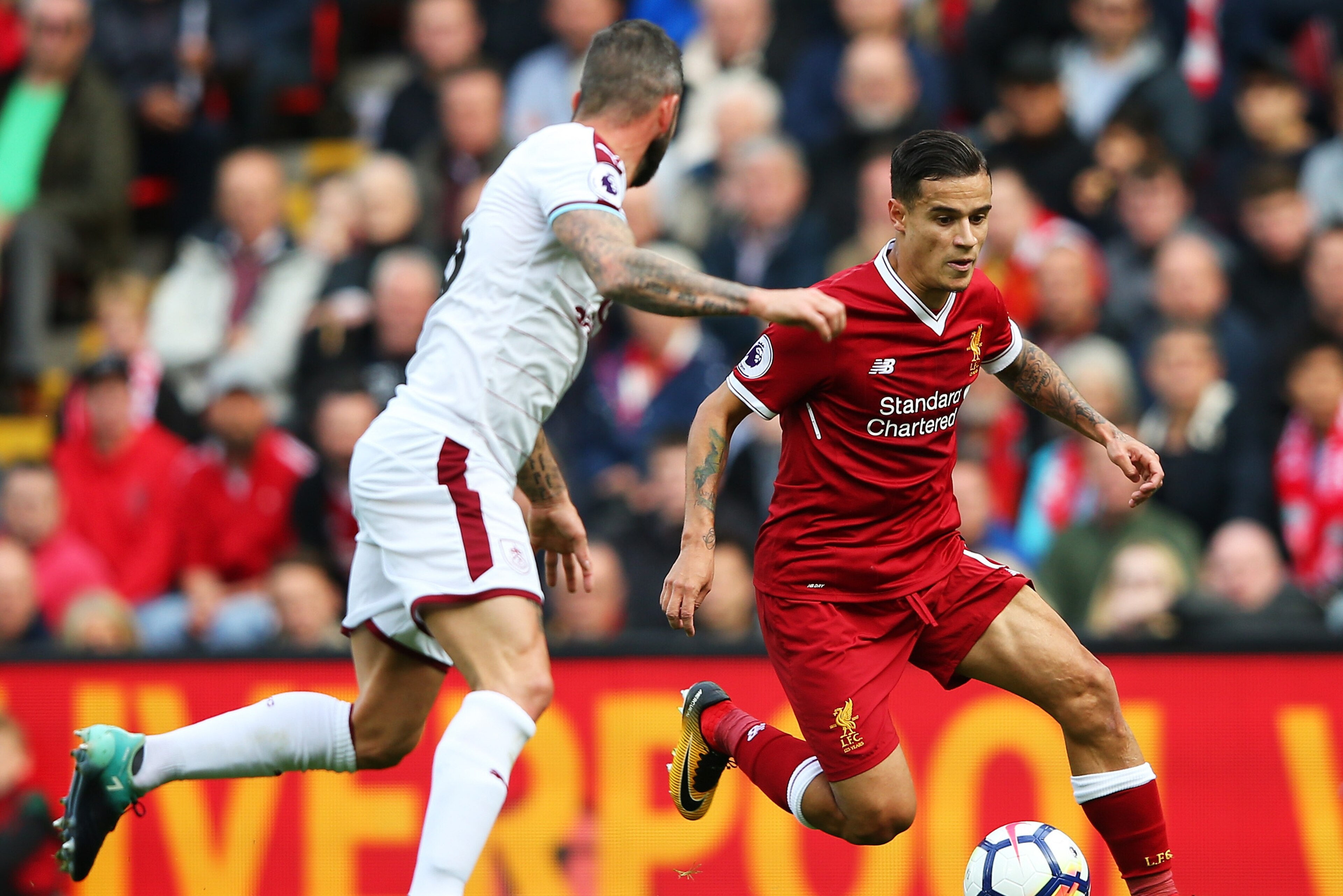 LIVERPOOL, ENGLAND - SEPTEMBER 16:  Philippe Coutinho of Liverpool attempts to get past Steven Defour of Burnley during the Premier League match between Liverpool and Burnley at Anfield on September 16, 2017 in Liverpool, England.  (Photo by Alex Livesey/