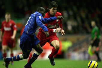 LIVERPOOL, ENGLAND - NOVEMBER 28:  Harry Kewell of Liverpool is tackled by Lauren of Arsenal  during the Barclays Premiership match between Liverpool and Arsenal at Anfield on November 28, 2004 in Liverpool, England.  (Photo by Clive Brunskill/Getty Image