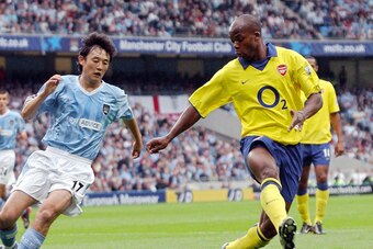 MANCHESTER, United Kingdom:  FILES - Picture taken 31 August 2003 in Manchester shows Arsenal's French Sylvain Wiltord (R) fighting for the ball with Manchester City's Jihai Sun during their Premiership clash at Manchester Stadium in Manchester. Bundeslig