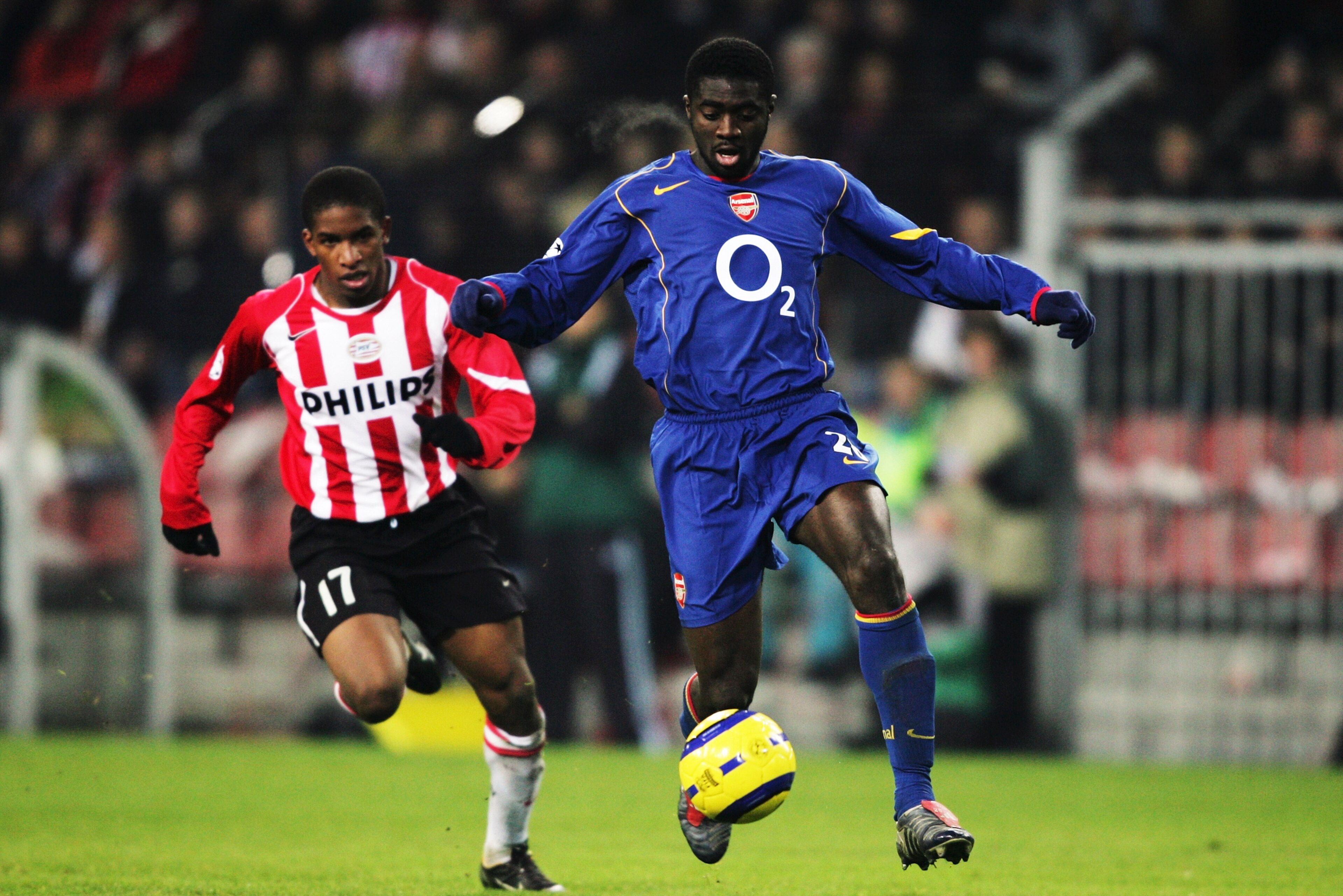 EINDHOVEN, NETHERLANDS - NOVEMBER 24:  Kolo Toure of Arsenal holds off Jefferson Farfan of PSV Eindhoven during the UEFA Champions League Group E match between PSV Eindhoven and Arsenal at the Phillips Stadium on November 24, 2004 in Eindhoven, Netherland