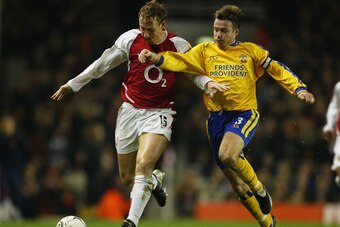 LONDON - FEBRUARY 10:  Ray Parlour of Arsenal battles for the ball with Graeme Le Saux of Southampton during the FA Barclaycard Premiership match between Arsenal and Southampton at Highbury on February 10, 2004 in London.  (Photo by Clive Mason/Getty Imag