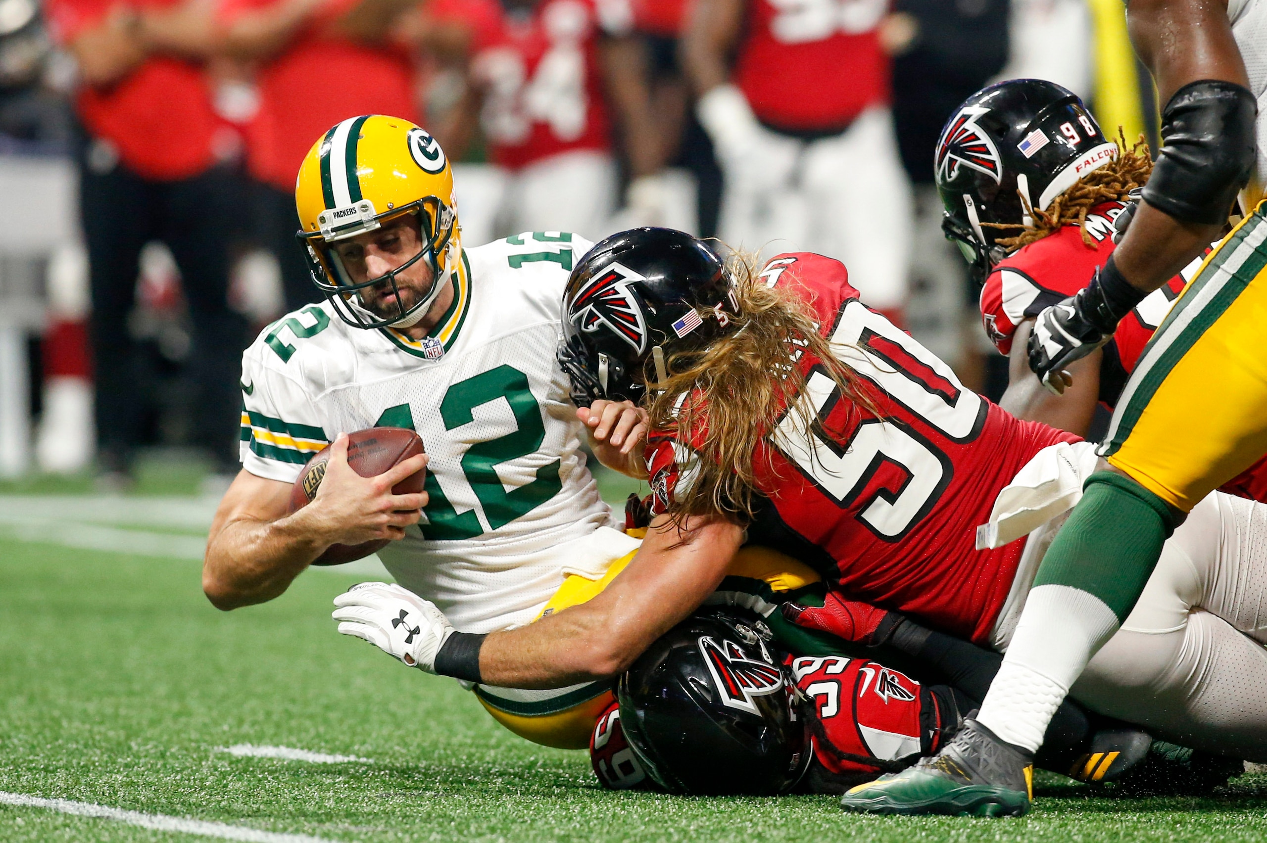 Sep 17, 2017; Atlanta, GA, USA; Green Bay Packers quarterback Aaron Rodgers (12) is sacked by Atlanta Falcons outside linebacker De'Vondre Campbell (59) and defensive end Brooks Reed (50) in the second quarter at Mercedes-Benz Stadium. Mandatory Credit: B