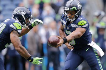 SEATTLE, WA - SEPTEMBER 17: Quarterback Russell Wilson #3 of the Seattle Seahawks hands off to running back Thomas Rawls #34 before the game against the San Francisco 49ers at CenturyLink Field on September 17, 2017 in Seattle, Washington. (Photo by Steph