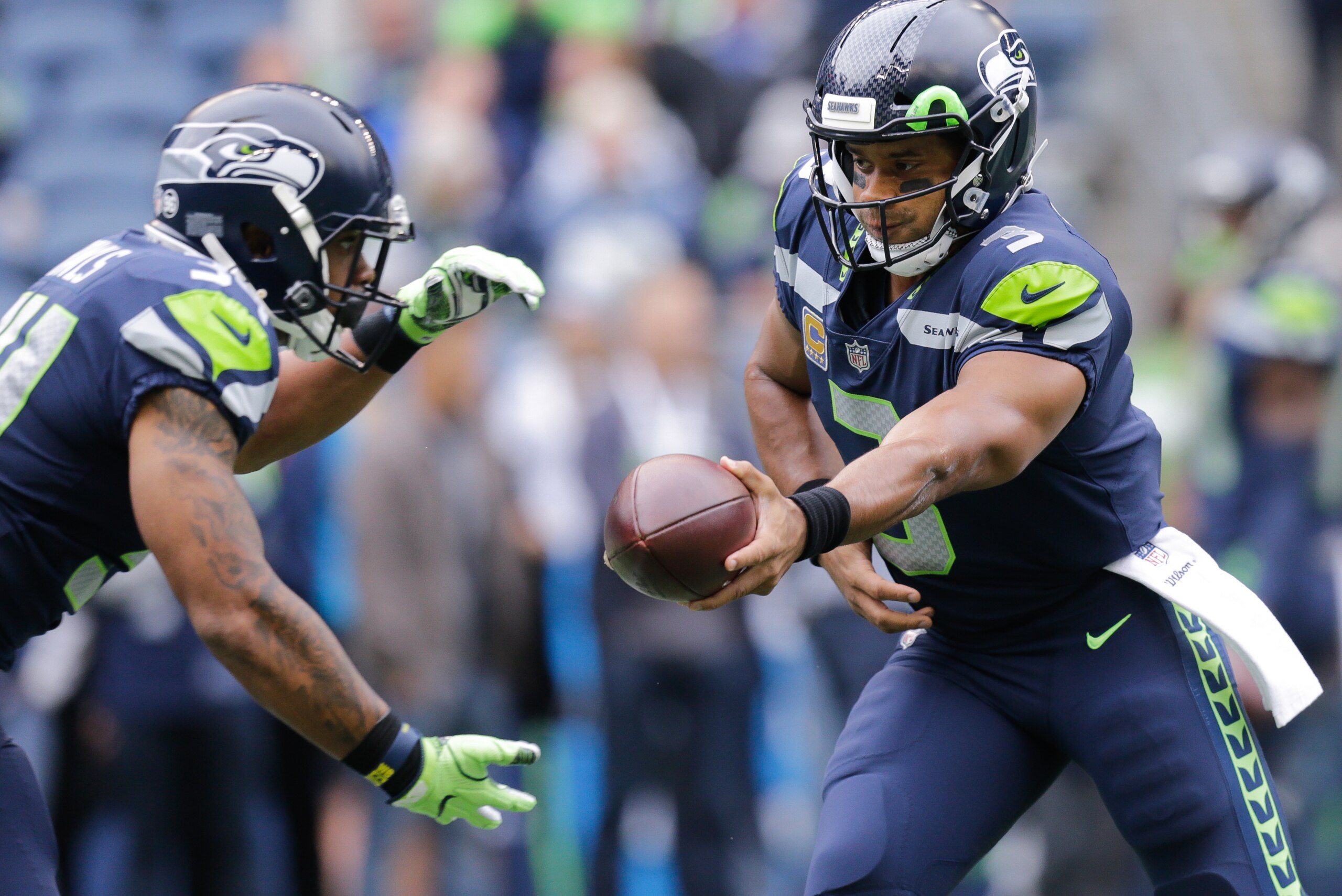 SEATTLE, WA - SEPTEMBER 17: Quarterback Russell Wilson #3 of the Seattle Seahawks hands off to running back Thomas Rawls #34 before the game against the San Francisco 49ers at CenturyLink Field on September 17, 2017 in Seattle, Washington. (Photo by Steph SEATTLE, WA - SEPTEMBER 17: Quarterback Russell Wilson #3 of the Seattle Seahawks hands off to running back Thomas Rawls #34 before the game against the San Francisco 49ers at CenturyLink Field on September 17, 2017 in Seattle, Washington. (Photo by Steph