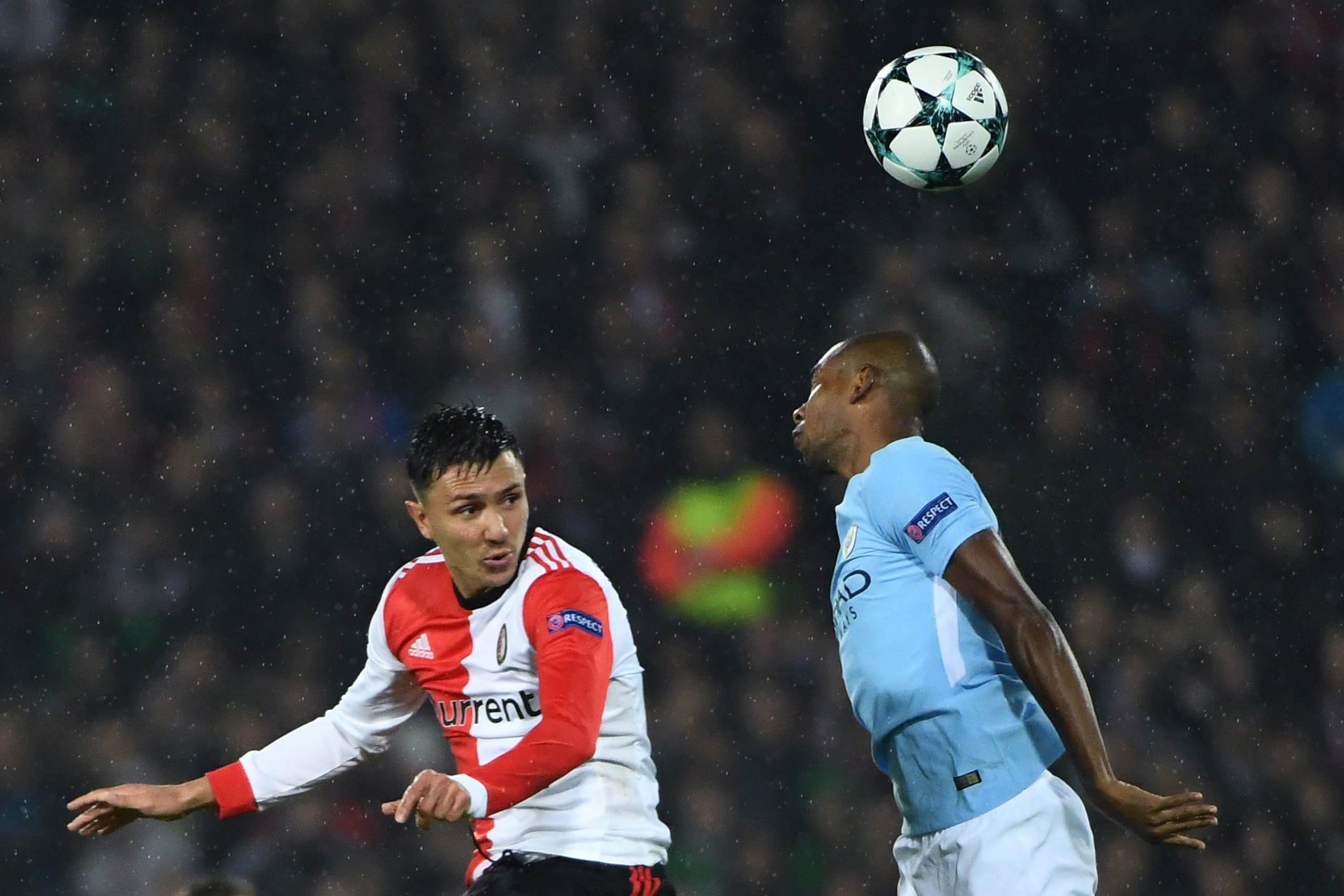 Manchester City's Brazilian midfielder Fernandinho (R) jumps for the ball with Feyenoord's Dutch striker Steven Berghuis  during the UEFA Champions League Group F football match between Feyenoord Rotterdam and Manchester City at the Feyenoord Stadium in R