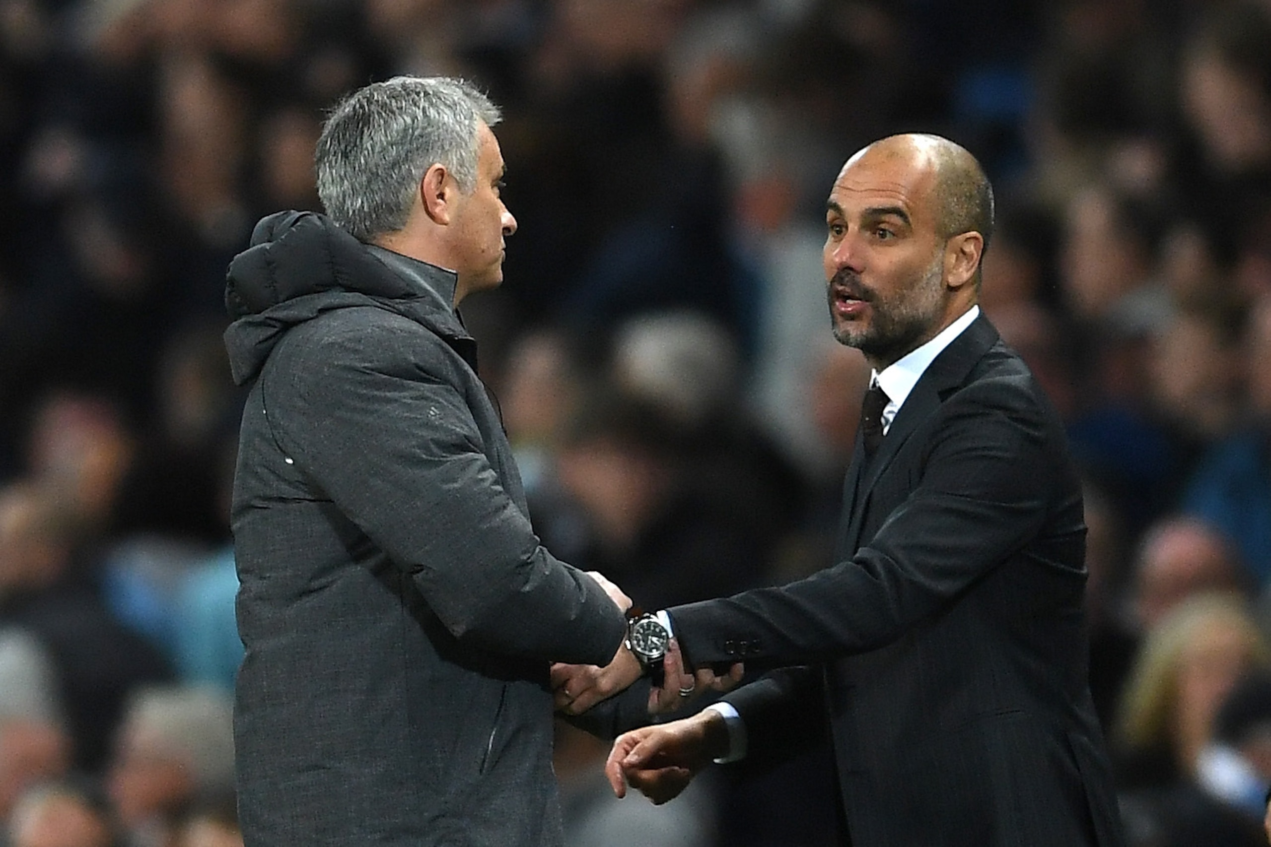 MANCHESTER, ENGLAND - APRIL 27:  Josep Guardiola, Manager of Manchester City and Jose Mourinho, Manager of Manchester United shake hands after the full time whistle during the Premier League match between Manchester City and Manchester United at Etihad St