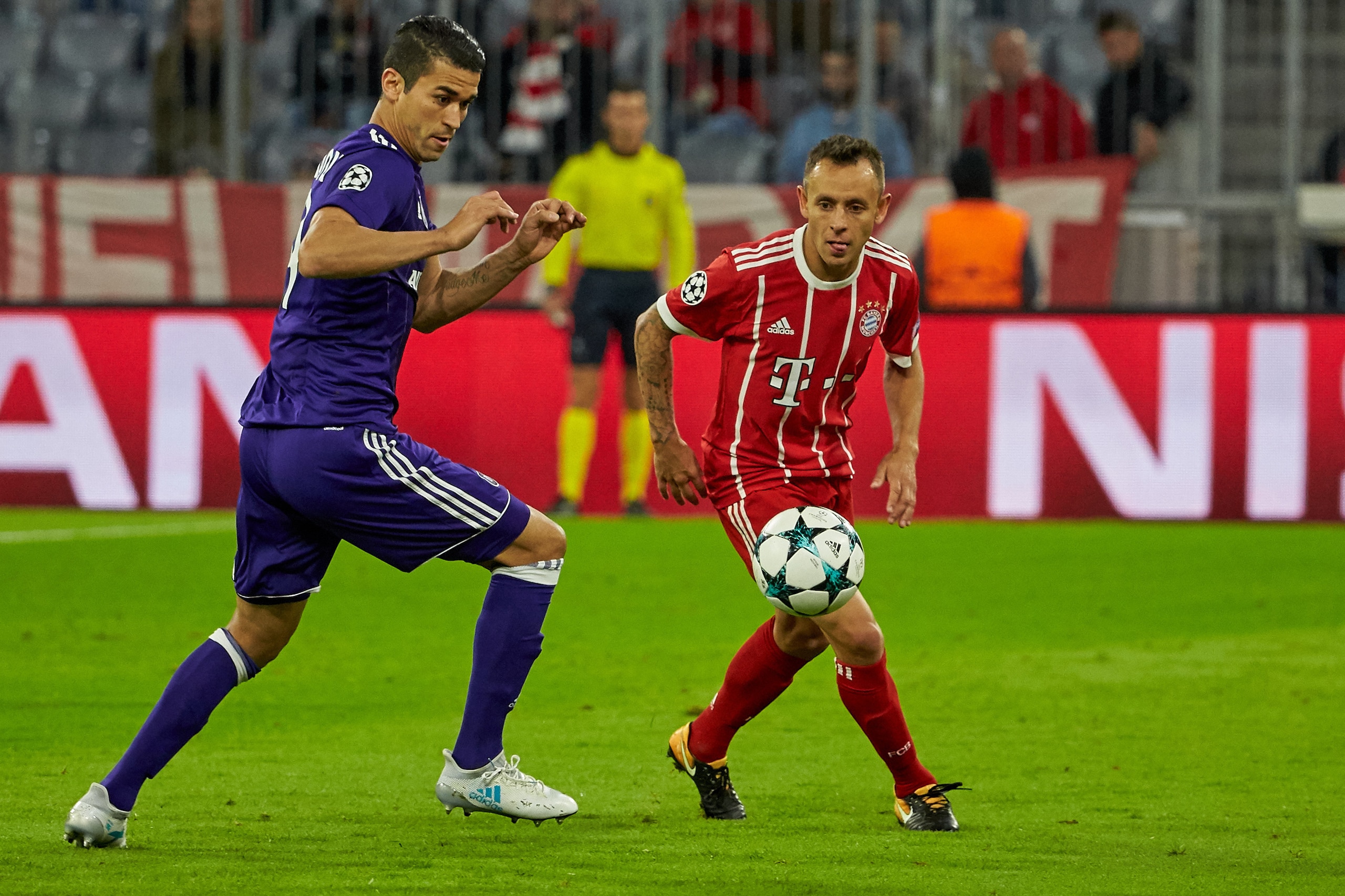 MUNICH, GERMANY - SEPTEMBER 12: Hamdi Harbaoui of Anderlecht and Rafinha of Bayern Muenchen battle for the ball during the UEFA Champions League group B match between Bayern Muenchen and RSC Anderlecht at Allianz Arena on September 12, 2017 in Munich, Ger