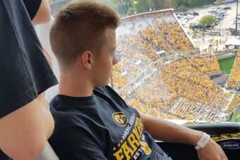 Mason Christensen sits at the window