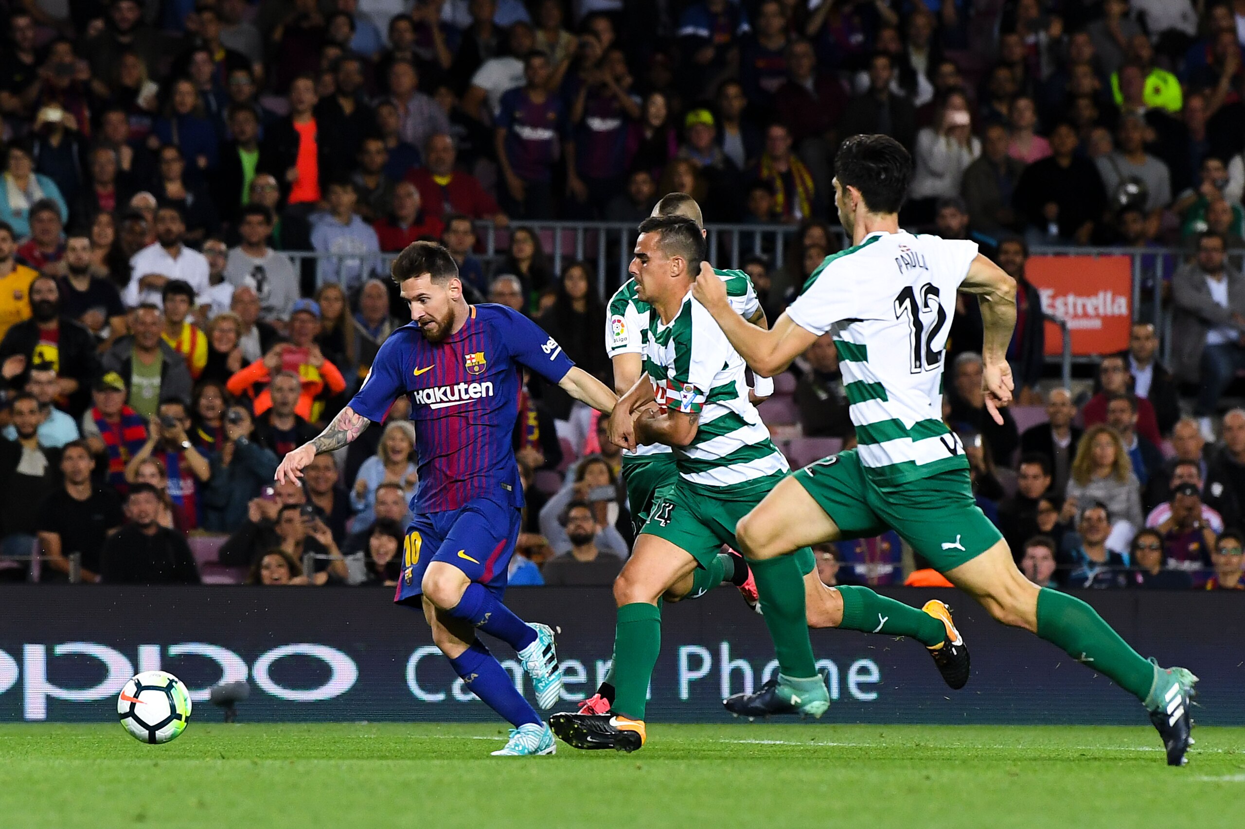 BARCELONA, SPAIN - SEPTEMBER 19:  Lionel Messi of FC Barcelona competes for the ball with SD Eibar players to score his team's fifth goal during the La Liga match between Barcelona and SD Eibar at Camp Nou on September 19, 2017 in Barcelona, Spain.  (Phot