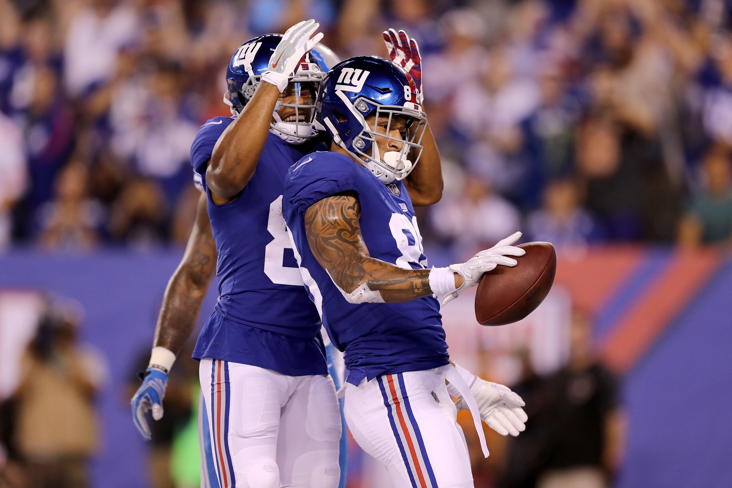 EAST RUTHERFORD, NJ - SEPTEMBER 18:  Evan Engram #88 of the New York Giants celebrates with his teammate after scoring an 18 yard touchdown in the second quarter against the Detroit Lions during their game at MetLife Stadium on September 18, 2017 in East 