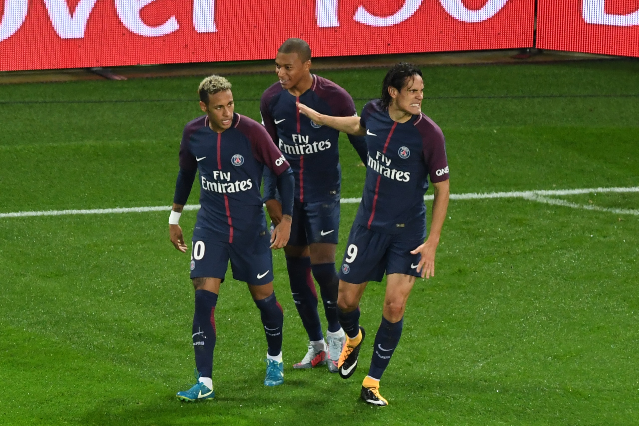 Paris Saint-Germain's Uruguayan forward Edinson Cavani (R) celebrates with Paris Saint-Germain's Brazilian forward Neymar (L) and Paris Saint-Germain's French forward Kylian Mbappe after scoring the opening goal during the French Ligue 1 football match be