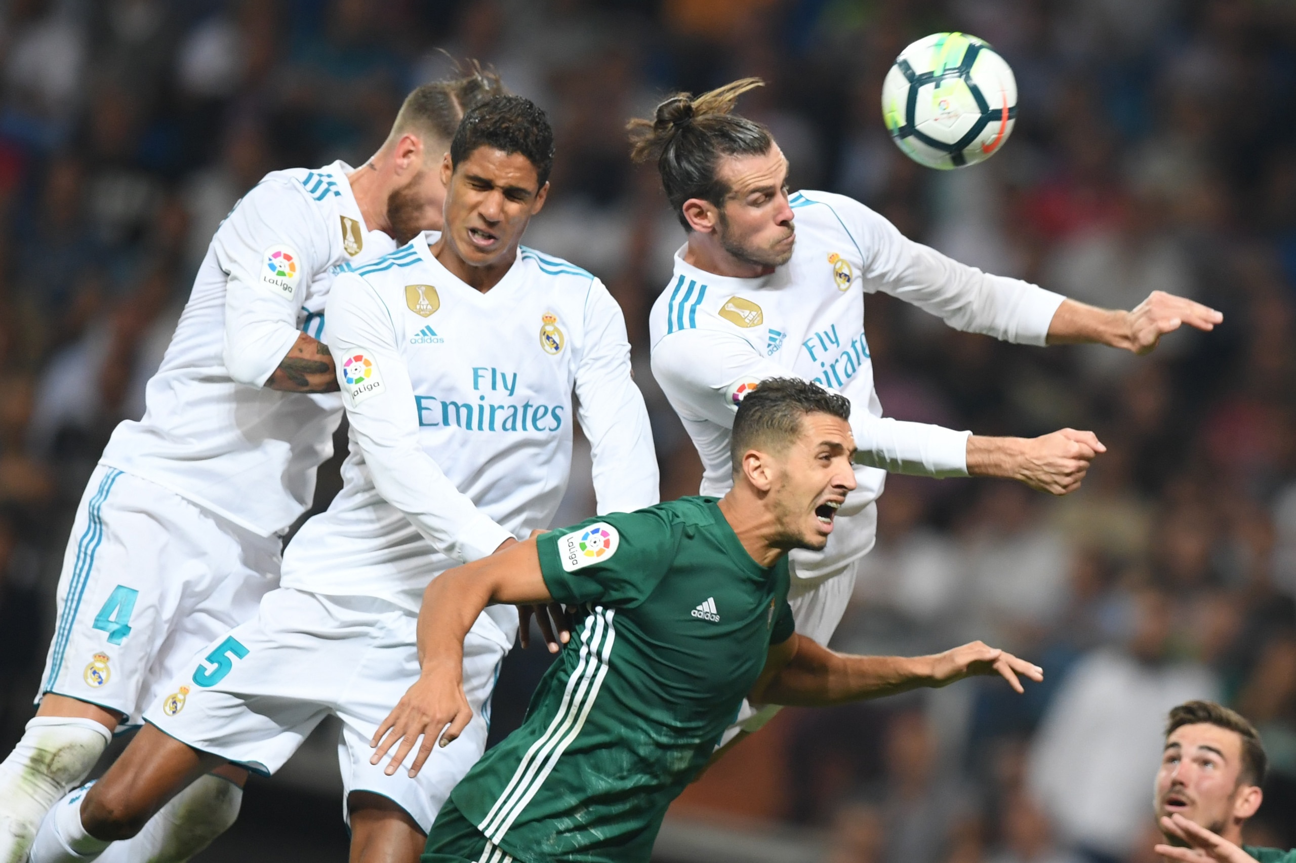 Real Madrid's defender from Spain Sergio Ramos (L), Real Madrid's defender from France Raphael Varane (2L) and Real Madrid's forward from Wales Gareth Bale (top R) vie with Real Betis' defender from Morocco Zou during the Spanish league football match Rea