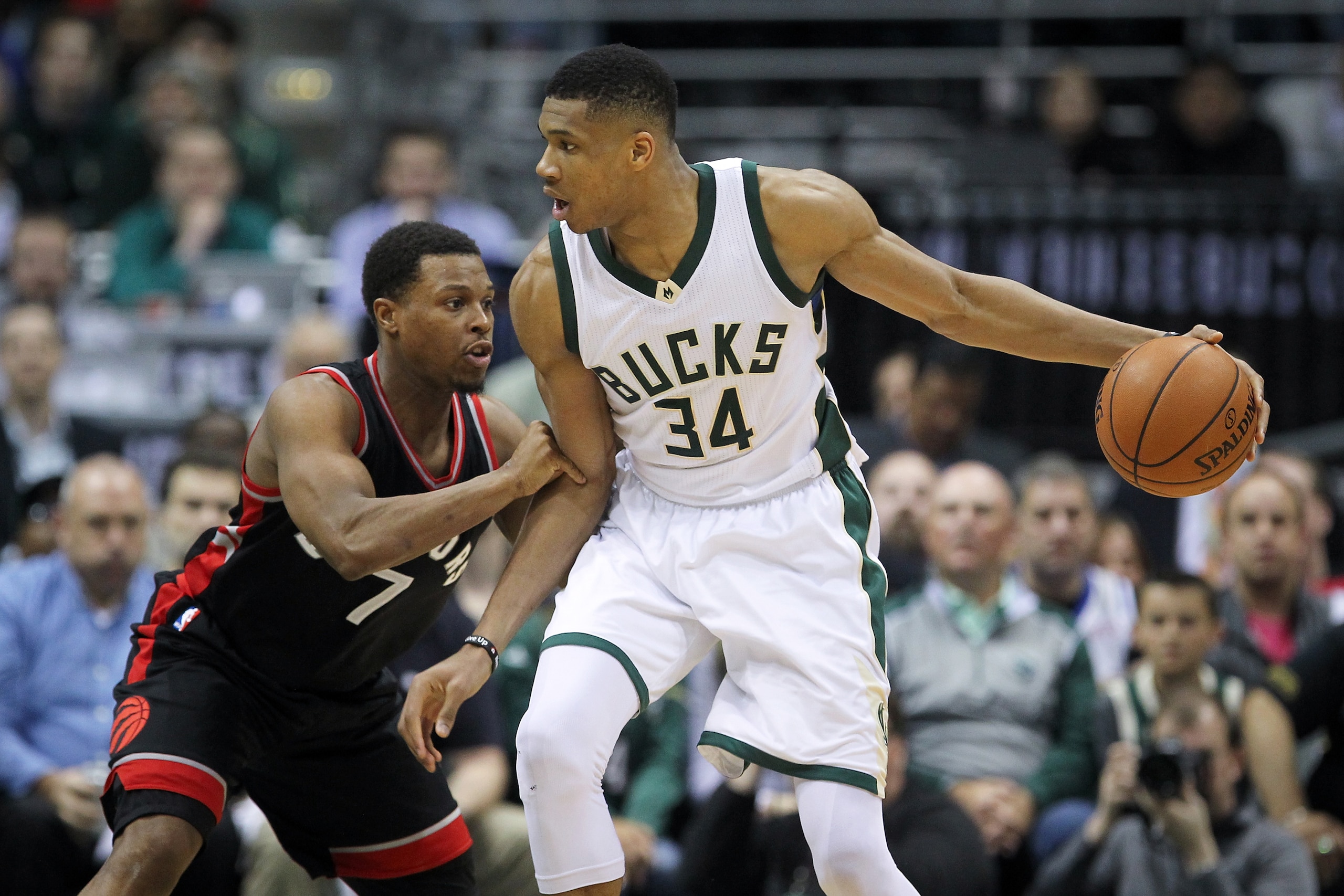 MILWAUKEE, WI - APRIL 27:  Giannis Antetokounmpo #34 of the Milwaukee Bucks dribbles the ball while being guarded by Kyle Lowry #7 of the Toronto Raptors in the fourth quarter in Game Six of the Eastern Conference Quarterfinals during the 2017 NBA Playoff