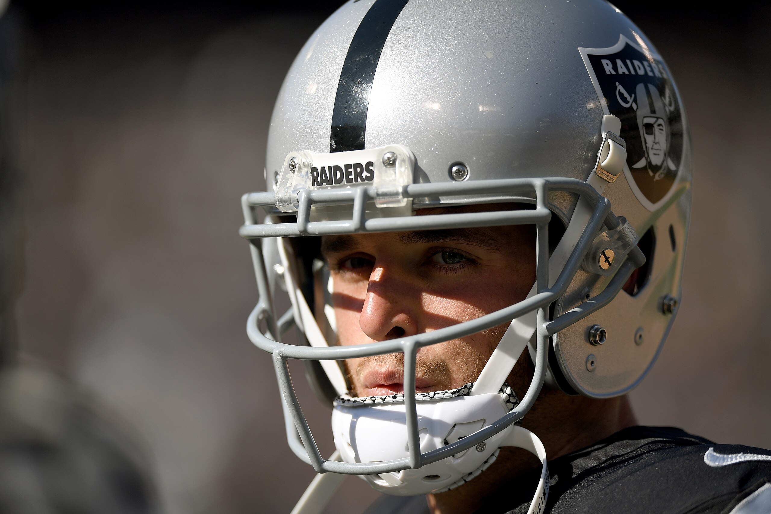 OAKLAND, CA - SEPTEMBER 17:  Derek Carr #4 of the Oakland Raiders looks on from the sidelines against the New York Jets during the fourth quarter of their NFL football game at Oakland-Alameda County Coliseum on September 17, 2017 in Oakland, California.  
