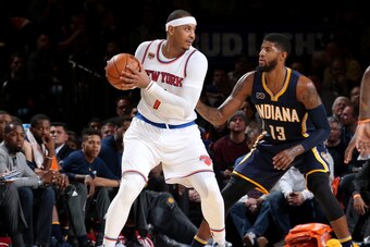 NEW YORK, NY - DECEMBER 20:  Carmelo Anthony #7 of the New York Knicks handles the ball against Paul George #13 of the Indiana Pacers during a game on December 20, 2016 at Madison Square Garden in New York City, New York. NOTE TO USER: User expressly ackn