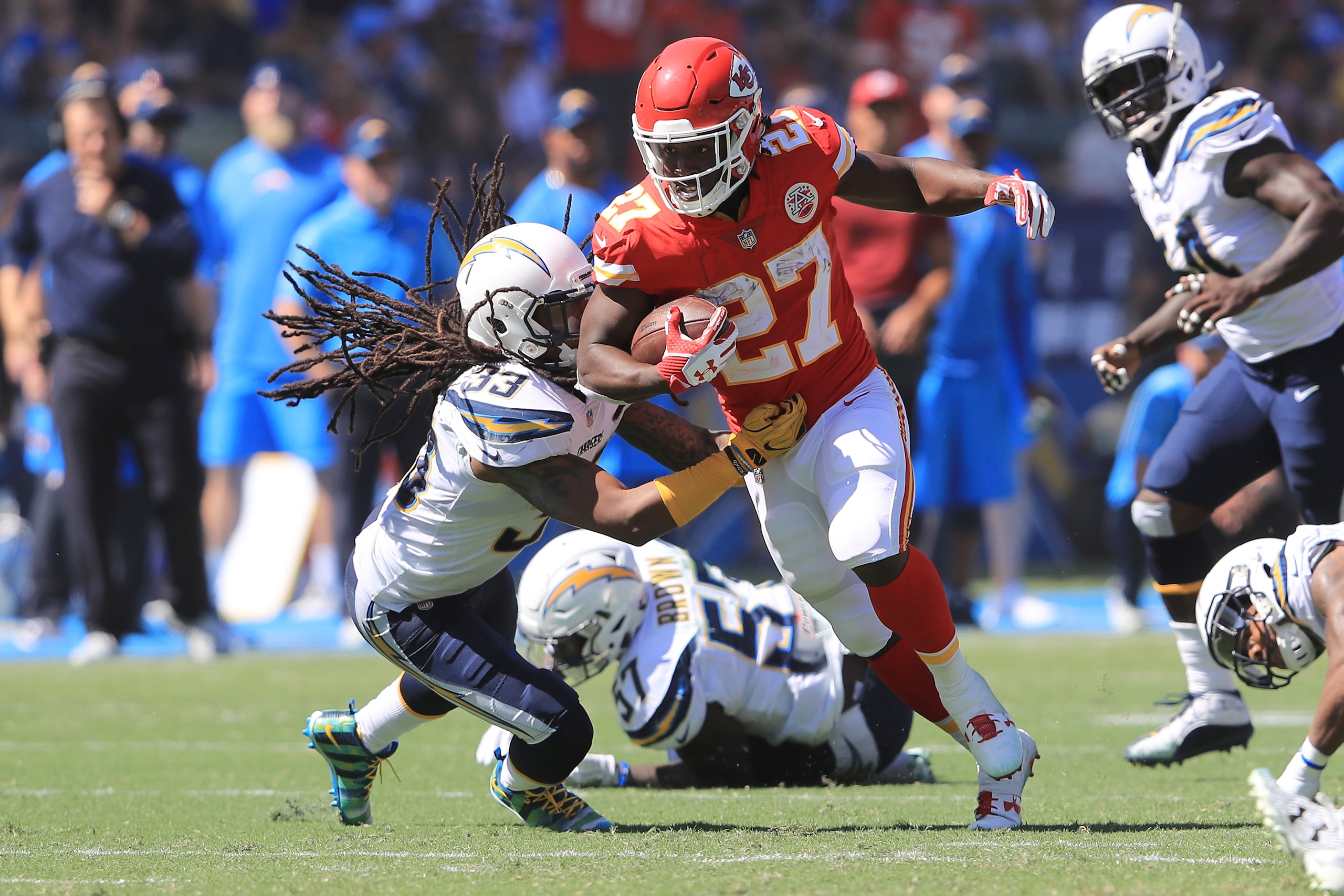 CARSON, CA - SEPTEMBER 24:  Kareem Hunt #27 of the Kansas City Chiefs avoids the tackle against Tre Boston #33 of the Los Angeles Chargers during the NFL game at the StubHub Center on September 24, 2017 in Carson, California.  (Photo by Sean M. Haffey/Get