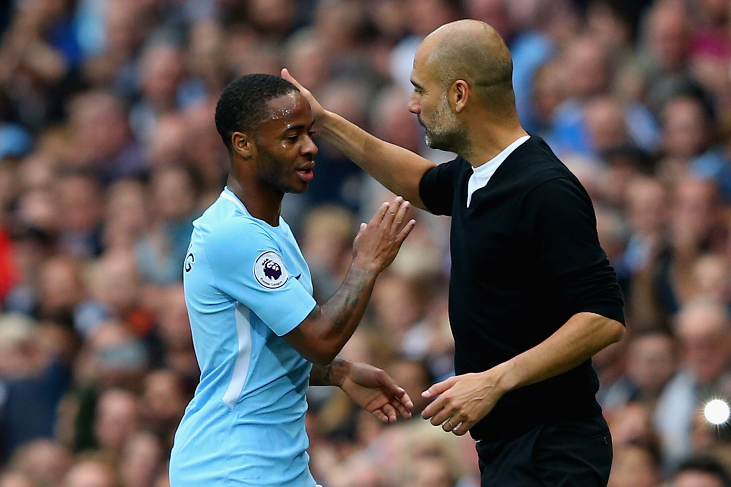 MANCHESTER, ENGLAND - SEPTEMBER 23:  Raheem Sterling of Manchester City is embraced by manager Josep Guardiola after substituted during the Premier League match between Manchester City and Crystal Palace at Etihad Stadium on September 23, 2017 in Manchest