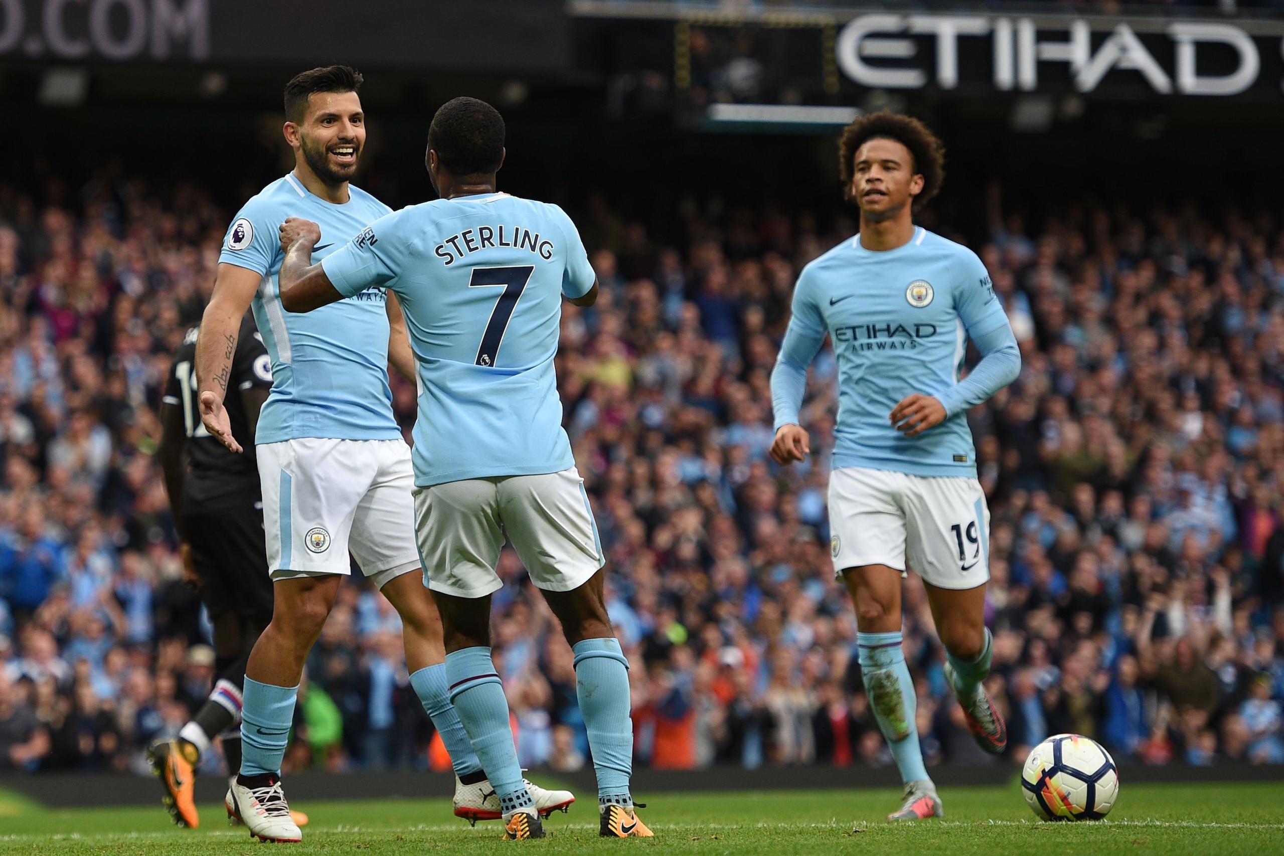 Manchester City's English midfielder Raheem Sterling (C) celebrates after scoring his secong goal with Manchester City's Argentinian striker Sergio Aguero (L) during the English Premier League football match between Manchester City and Crystal Palace at t