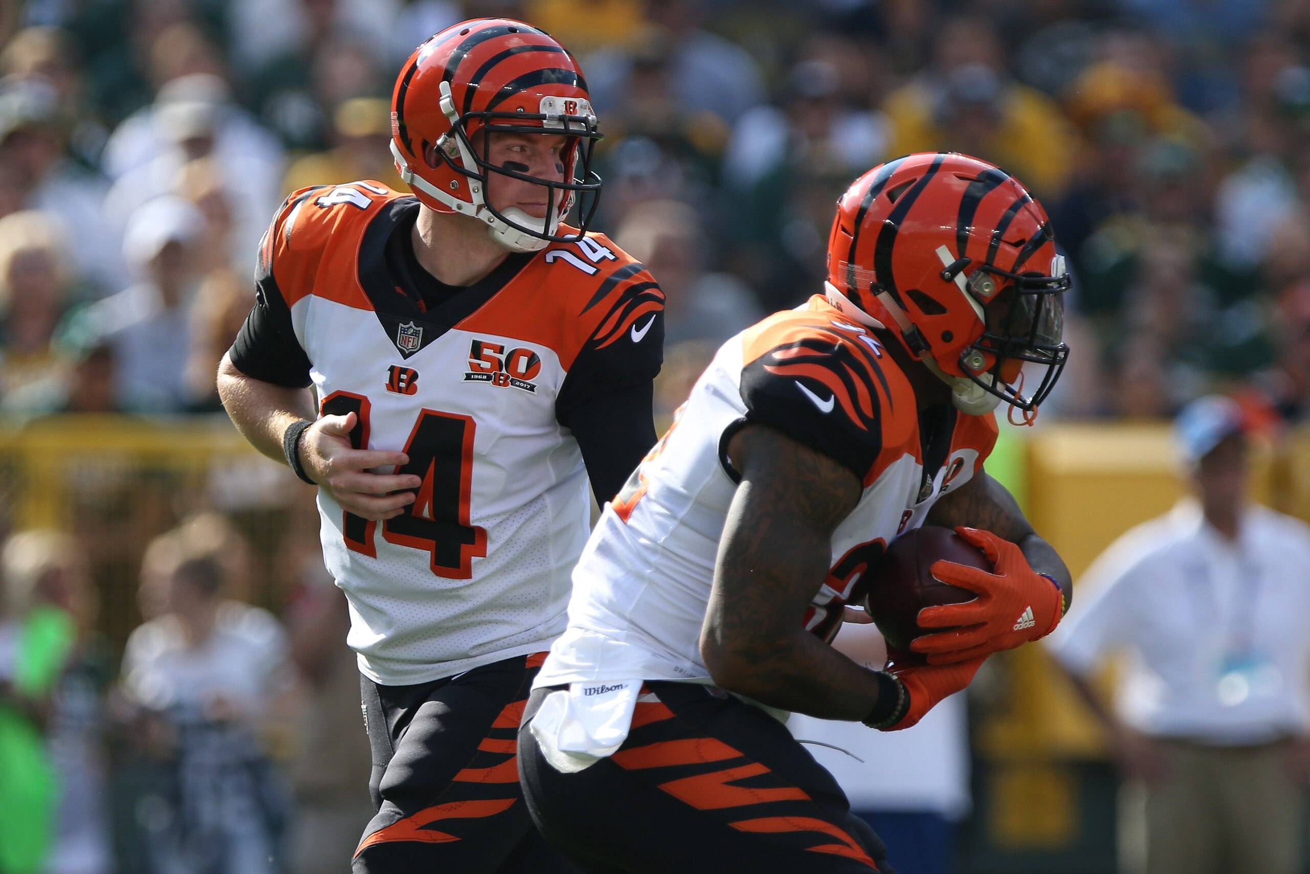 GREEN BAY, WI - SEPTEMBER 24:  Andy Dalton #14 of the Cincinnati Bengals hands off to Jeremy Hill #32 of the Cincinnati Bengals during the first quarter against the Green Bay Packers at Lambeau Field on September 24, 2017 in Green Bay, Wisconsin.  (Photo 