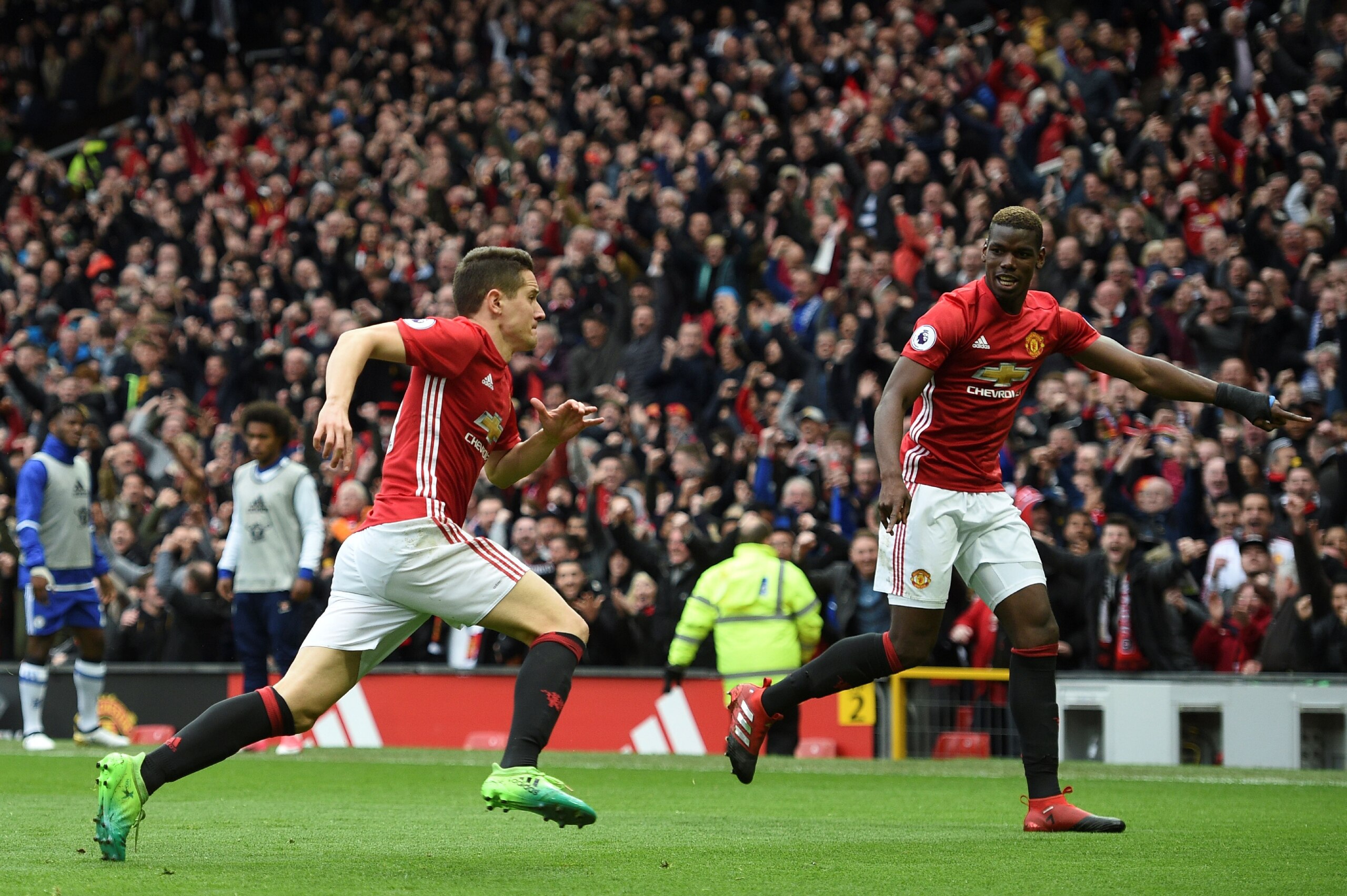 Manchester United's Spanish midfielder Ander Herrera (L) celebrates scoring their second goal with Manchester United's French midfielder Paul Pogba during the English Premier League football match between Manchester United and Chelsea at Old Trafford in M Manchester United's Spanish midfielder Ander Herrera (L) celebrates scoring their second goal with Manchester United's French midfielder Paul Pogba during the English Premier League football match between Manchester United and Chelsea at Old Trafford in M
