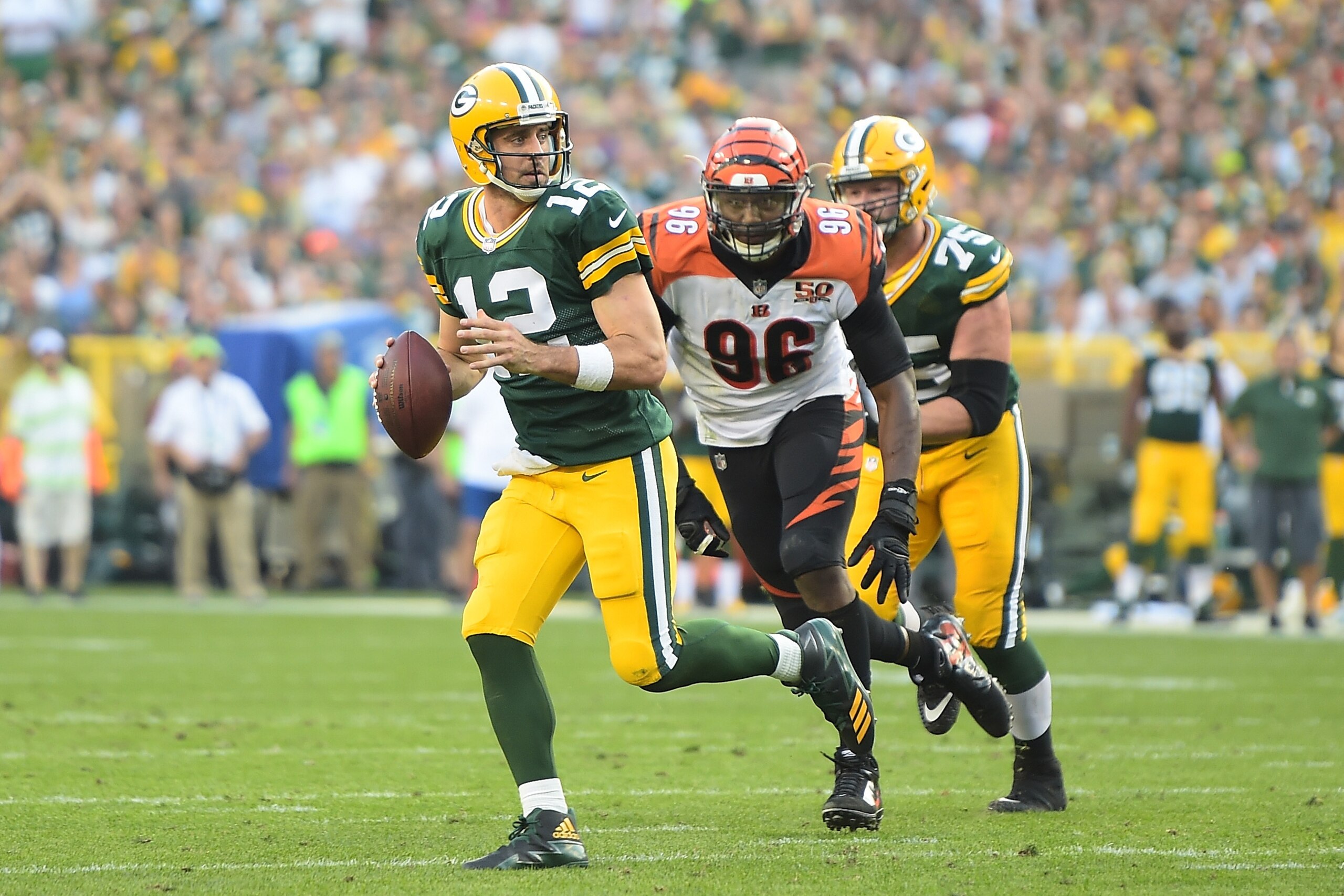 GREEN BAY, WI - SEPTEMBER 24:  Aaron Rodgers #12 of the Green Bay Packers rolls out looking to pass during the fourth quarter against the Cincinnati Bengals at Lambeau Field on September 24, 2017 in Green Bay, Wisconsin.  (Photo by Stacy Revere/Getty Imag