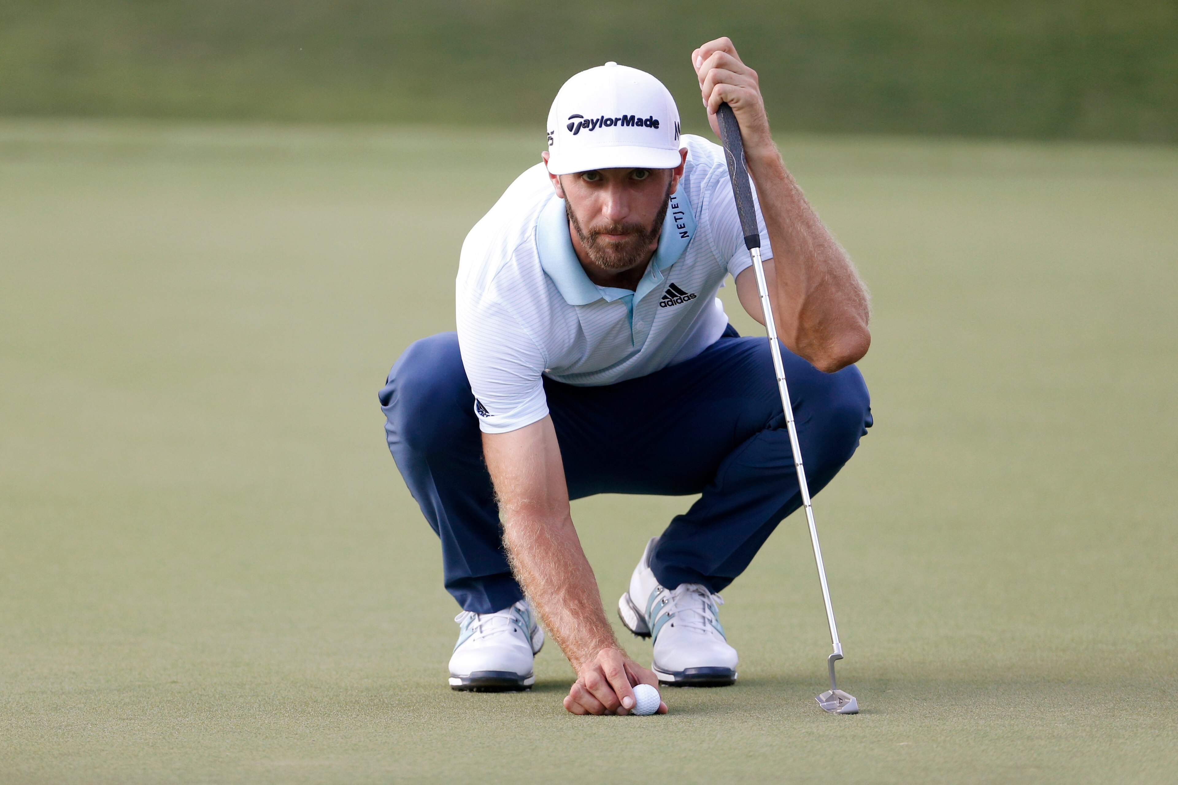 Sep 21, 2017; Atlanta, GA, USA;  Dustin Johnson lines up his putt on the 18th green during the first round of the Tour Championship golf tournament at East Lake Golf Club. Mandatory Credit: Brett Davis-USA TODAY Sports