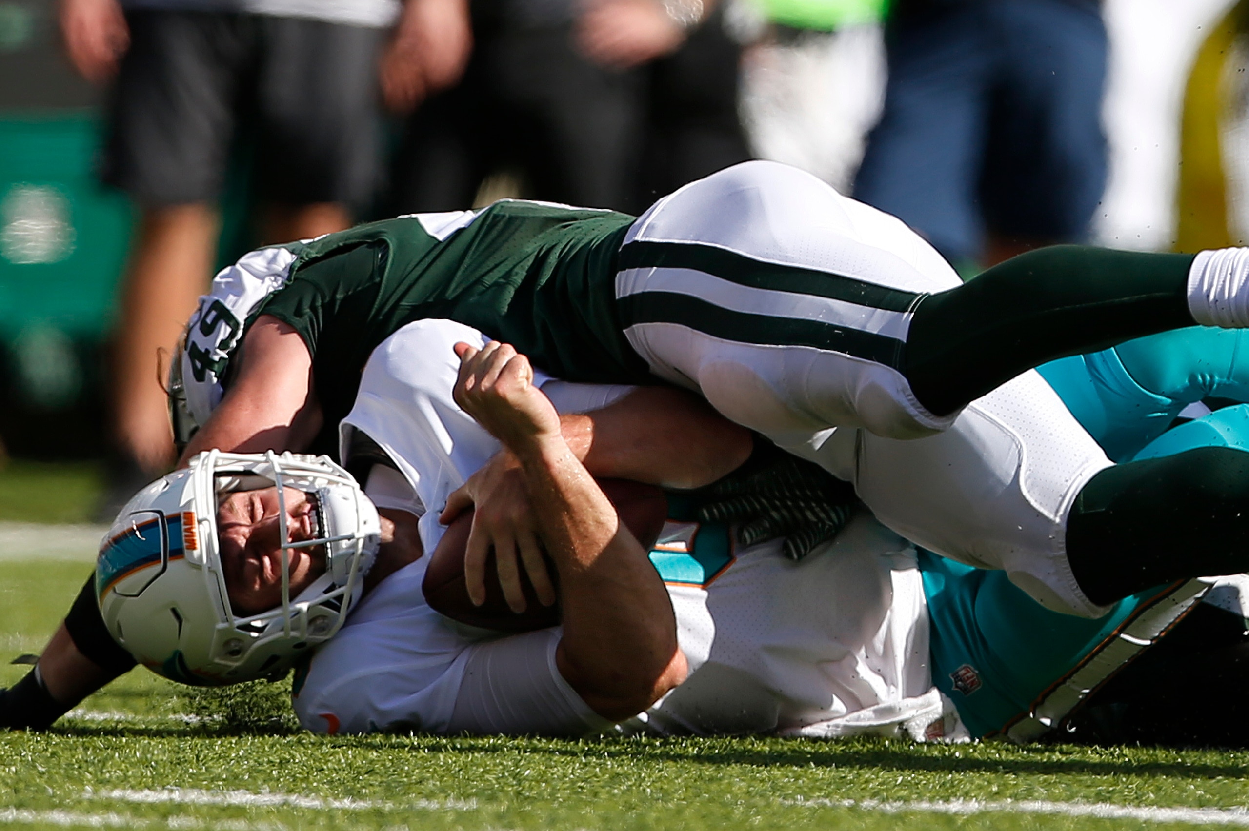 EAST RUTHERFORD, NJ - SEPTEMBER 24: Jay Cutler #6 of the Miami Dolphins is sacked by Dylan Donahue #49 of the New York Jets during the second half of an NFL game at MetLife Stadium on September 24, 2017 in East Rutherford, New Jersey. The New York Jets de