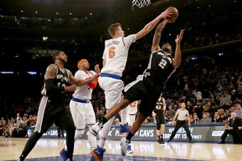 NEW YORK, NY - FEBRUARY 12:  Kristaps Porzingis #6 of the New York Knicks blocks a shot by Kawhi Leonard #2 of the San Antonio Spurs in the fourth quarter at Madison Square Garden on February 12, 2017 in New York City. NOTE TO USER: User expressly acknowl