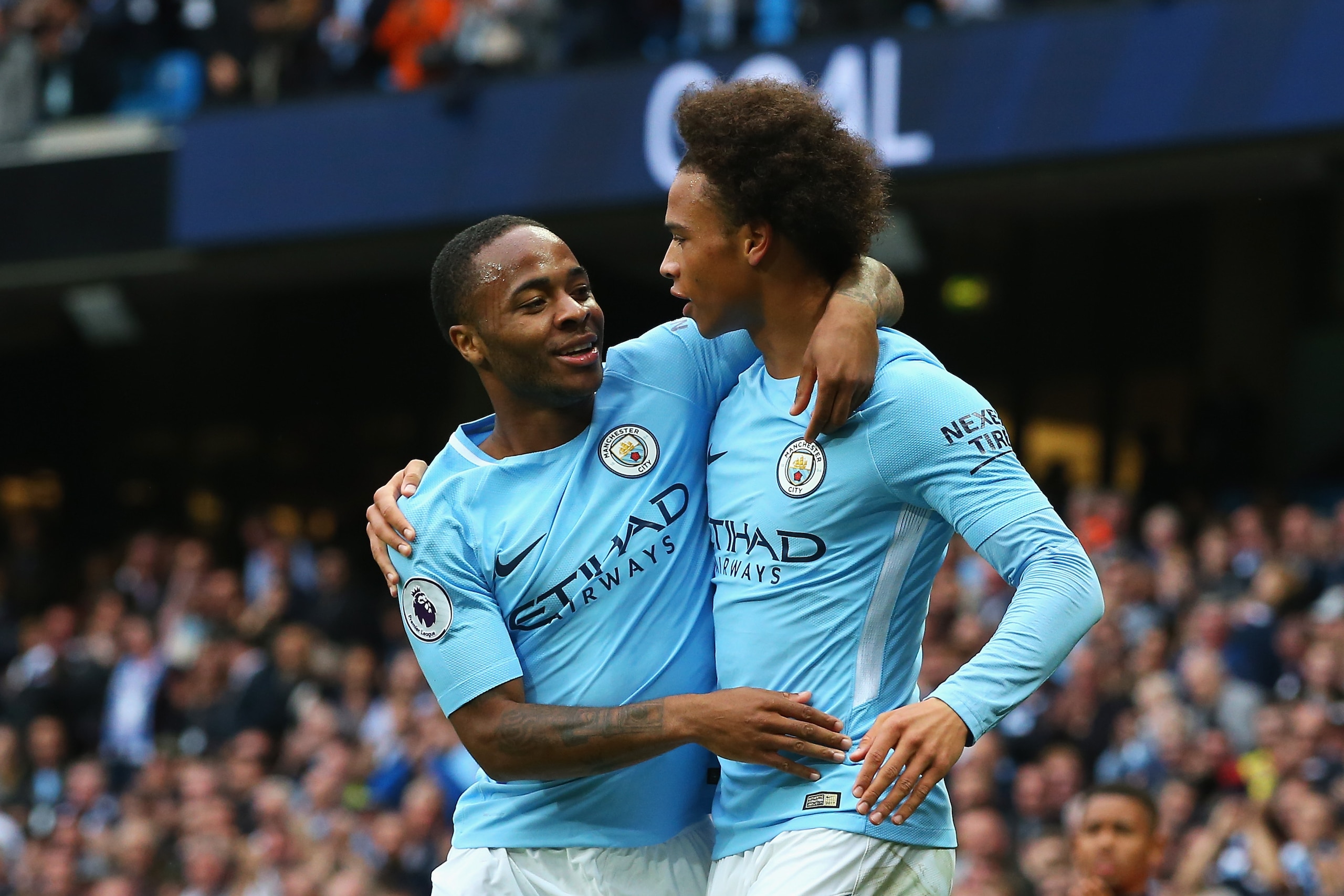 MANCHESTER, ENGLAND - SEPTEMBER 23:  Raheem Sterling (L) of Manchester City celebrates scoring his sides second goal with his team mate Leroy Sane (R) during the Premier League match between Manchester City and Crystal Palace at Etihad Stadium on Septembe