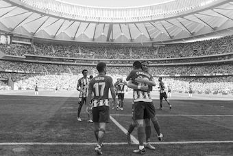 MADRID, SPAIN - SEPTEMBER 23: (EDITORS NOTE: Image has been converted to black and white.) Yannick Carrasco of Club Atletico de Madrid celebrates with Felipe Luis after scoring his teamÕs opening goal during the La Liga match between Atletico Madrid and S