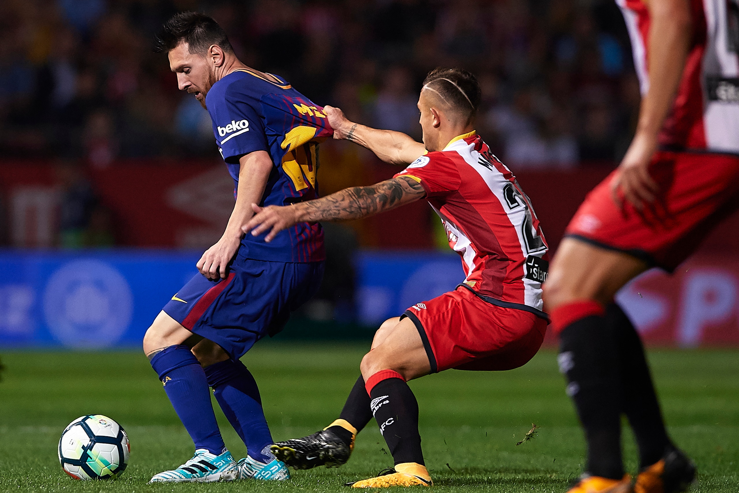 GIRONA, SPAIN - SEPTEMBER 23:  Lionel Messi of Barcelona is tackled by Pablo Maffeo of Girona during the La Liga match between Girona and Barcelona at Municipal de Montilivi Stadium on September 23, 2017 in Girona, Spain.  (Photo by Manuel Queimadelos Alo